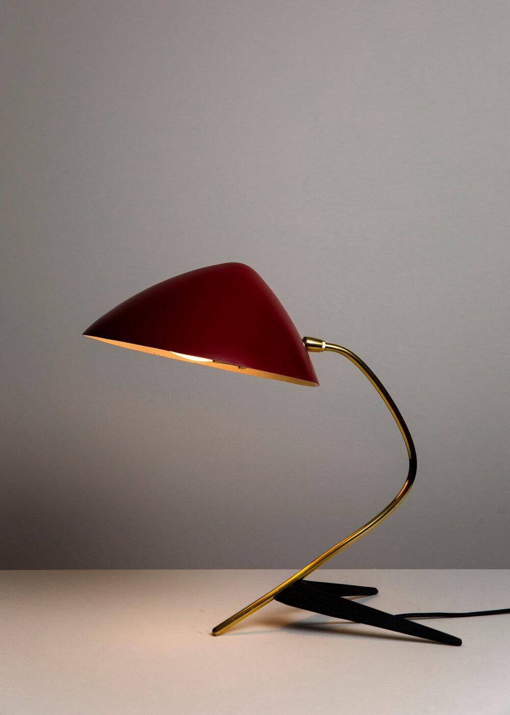 Large crow foot lamp by Stürzenhofecker and Becker for Gebrüder Cosack. Red Enameled hood-like shade, curved brass stem with brass pivot, black enameled steel foot. 60 watts E-26 Edison medium base incandescent bulb recommended or higher if