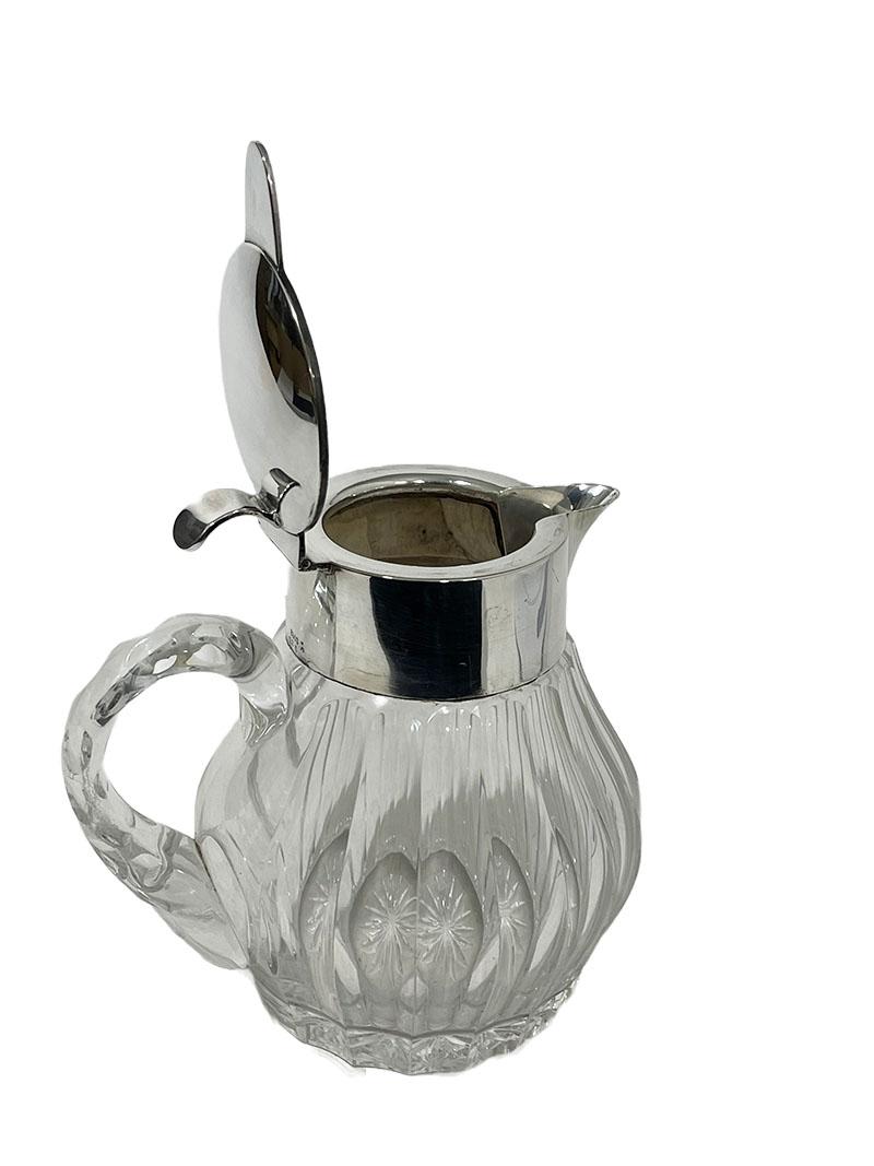 Gebrüder Deyhle, Schwabisch Gmund, early 20th century Silver mounted cut-glass pitcher 

Silver mounted cut-glass pitcher in pumpkin shaped form with cylindrical silver collar, short spout handle and a hinged domed cover. Marked by Gebruder Deyhle