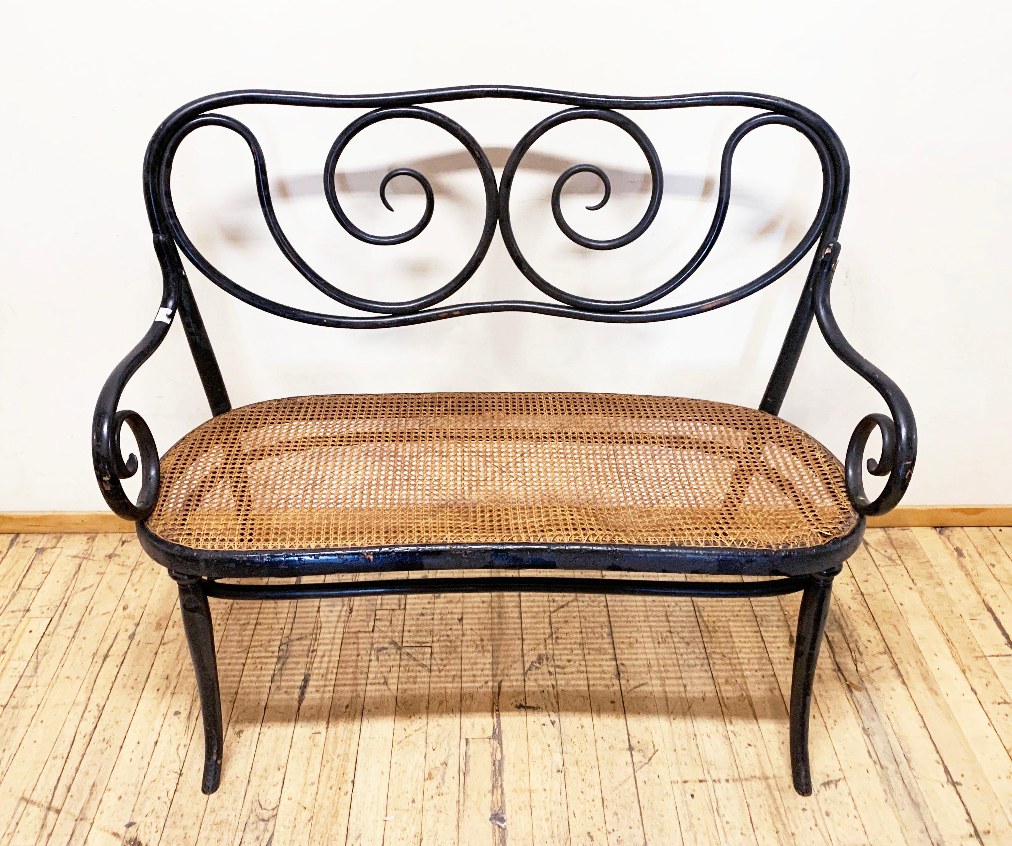 Beautiful Settee by Thonet and featured in their 1904 catalog. Most likely designed turn of the century (late 1800s).
This item does need to visit a restore wood shop for repair. The left arm has some issues that will need attention before use.