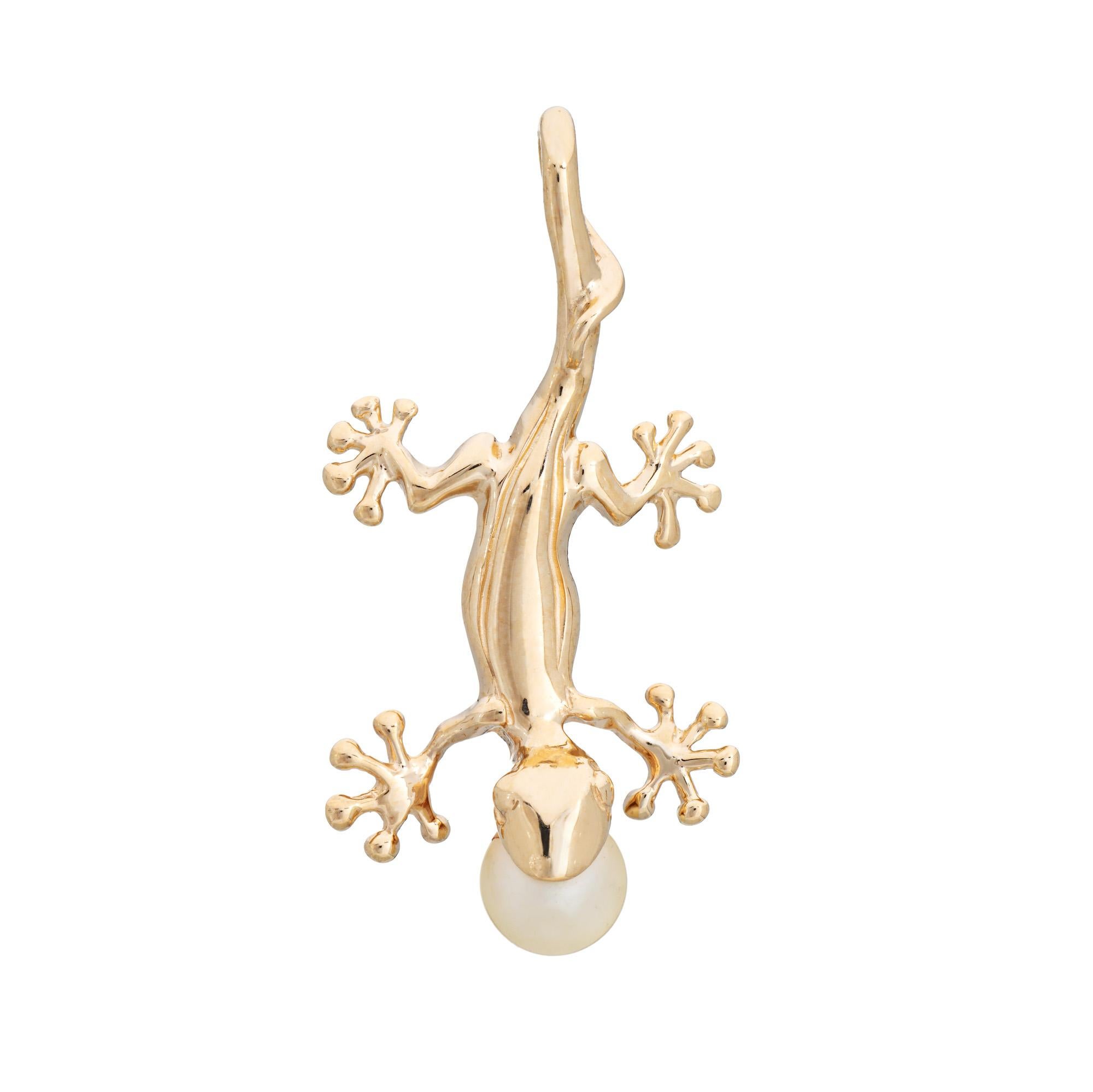 Finely detailed Gecko pendant crafted in 14k yellow gold.  

Cultured pearl measures 5.5mm.  

The beautifully detailed pendant highlights a slinky gecko. With webbed feet and a cultured pearl set into the mouth, the pendant makes a fun statement.