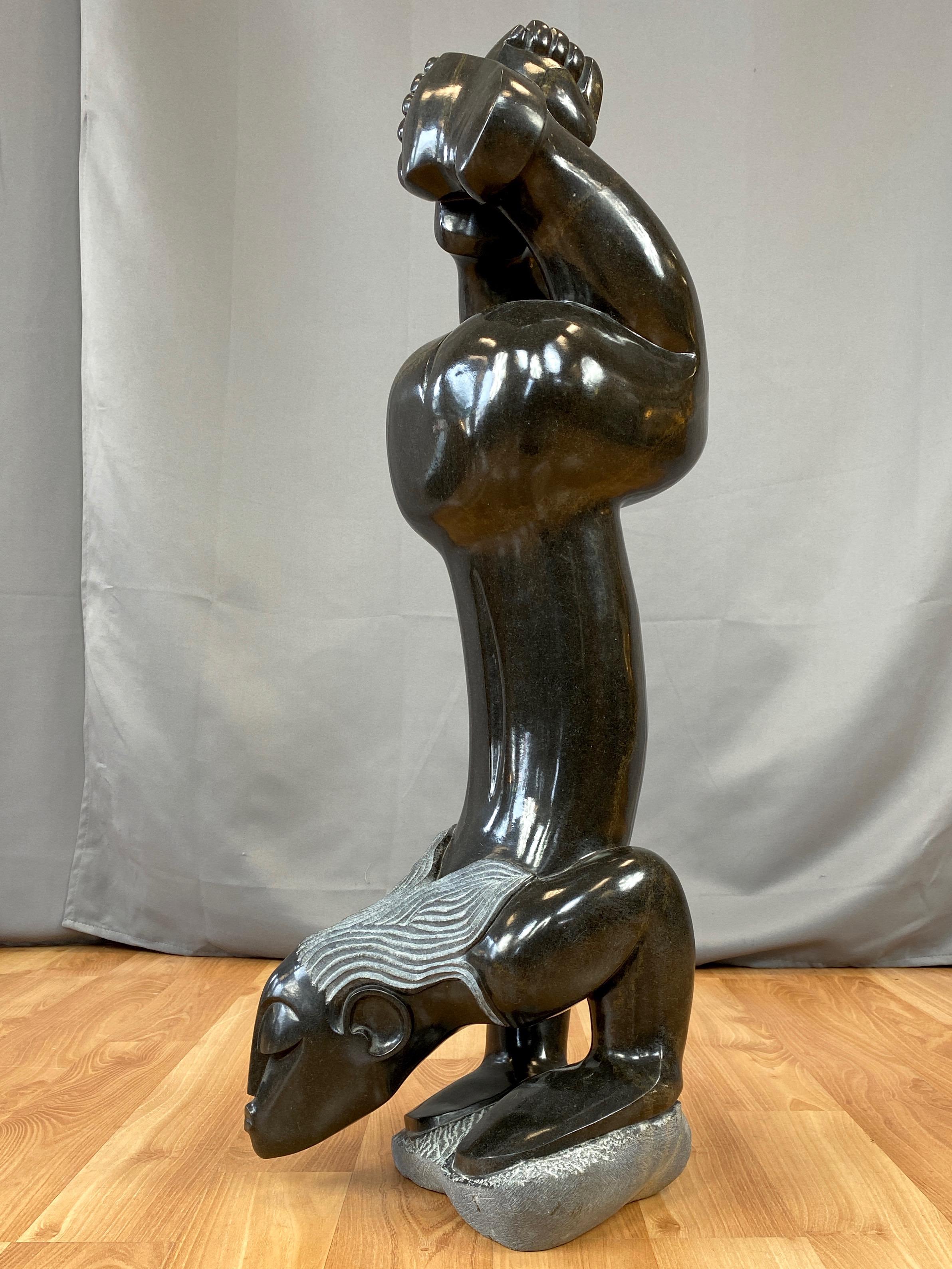 A very impressive signed Shona sculpture in springstone titled “Exercising” by important Arizona-based Zimbabwean artist Gedion Nyanhongo.

Exquisitely rendered and reverent depiction of the female form exudes serene strength and Zimbabwe’s singular