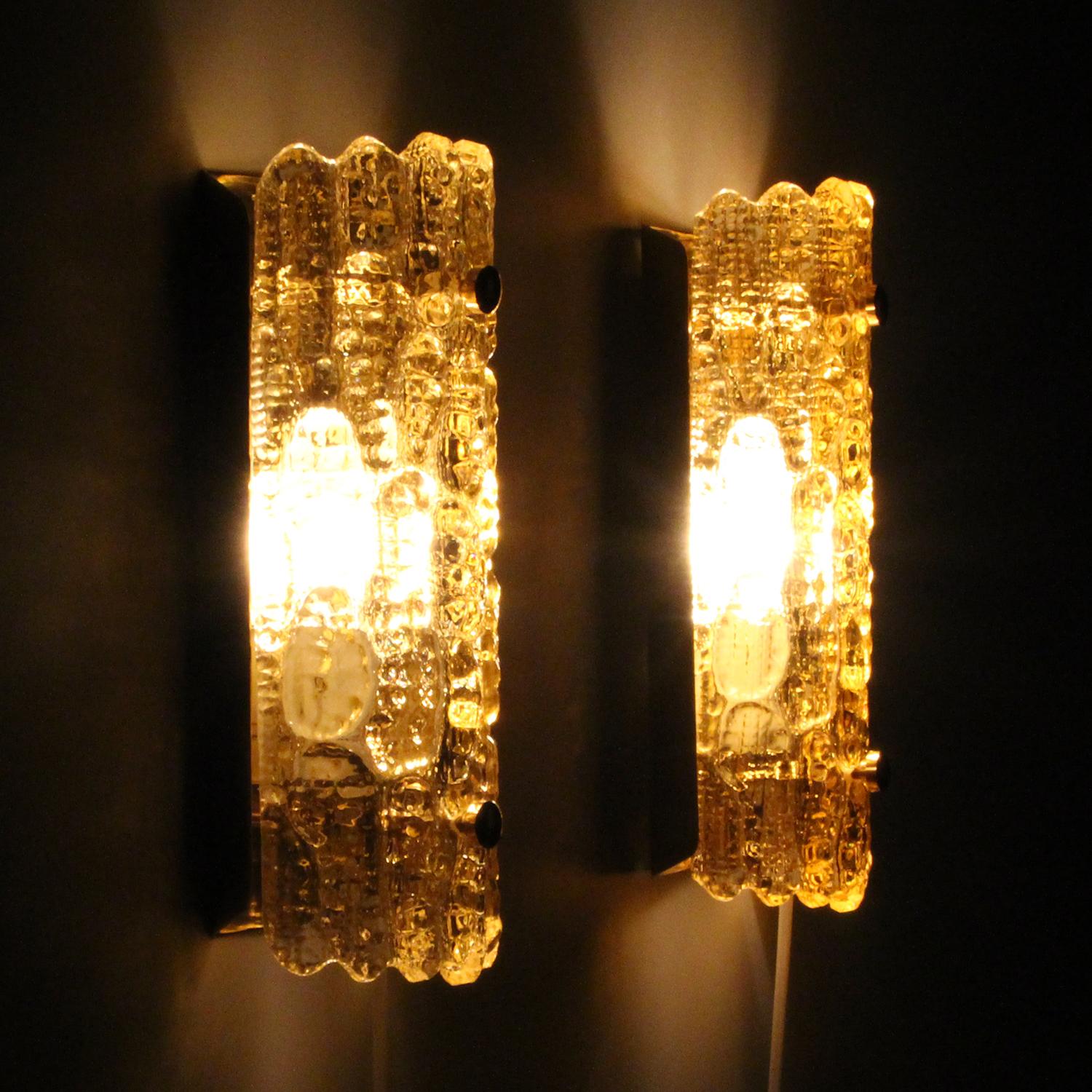 Gefion Sconces (pair) - pair of champagne colored crystal glass wall lamps by Carl Fagerlund for Lyfa and Swedish Orrefors in the 1960s, in very good vintage condition.

Each sconce is made of a thick champagne colored crystal glass piece, curved