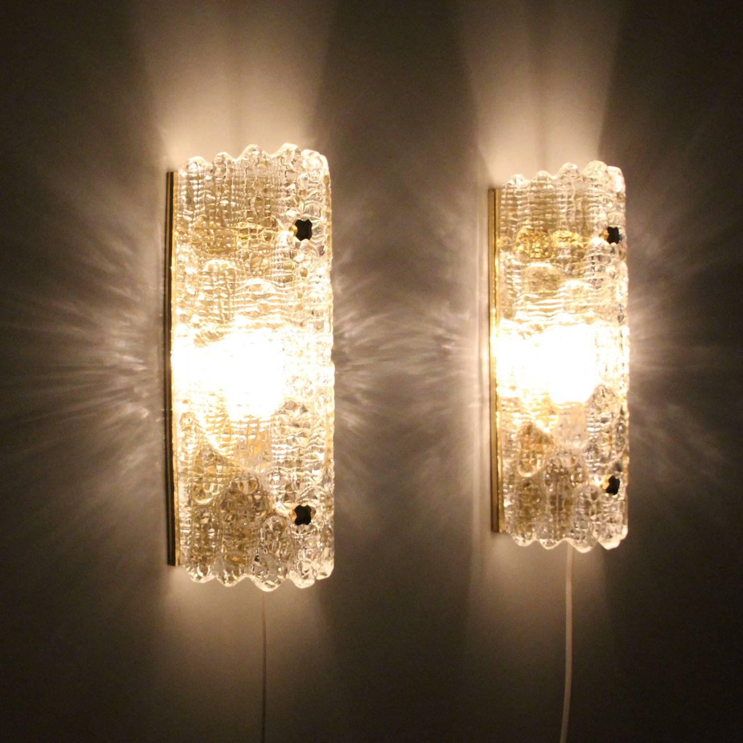 Gefion Sconces (pair), pair of crystal glass wall lights by Carl Fagerlund for Lyfa and Swedish Orrefors in the 1960s - beautiful pair of wall lamps in excellent vintage condition.

Each sconce is made of a thick clear crystal glass piece, curved