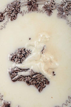 Gefle, Sweden. Round faience plate with putti figures, c. 1880/90s