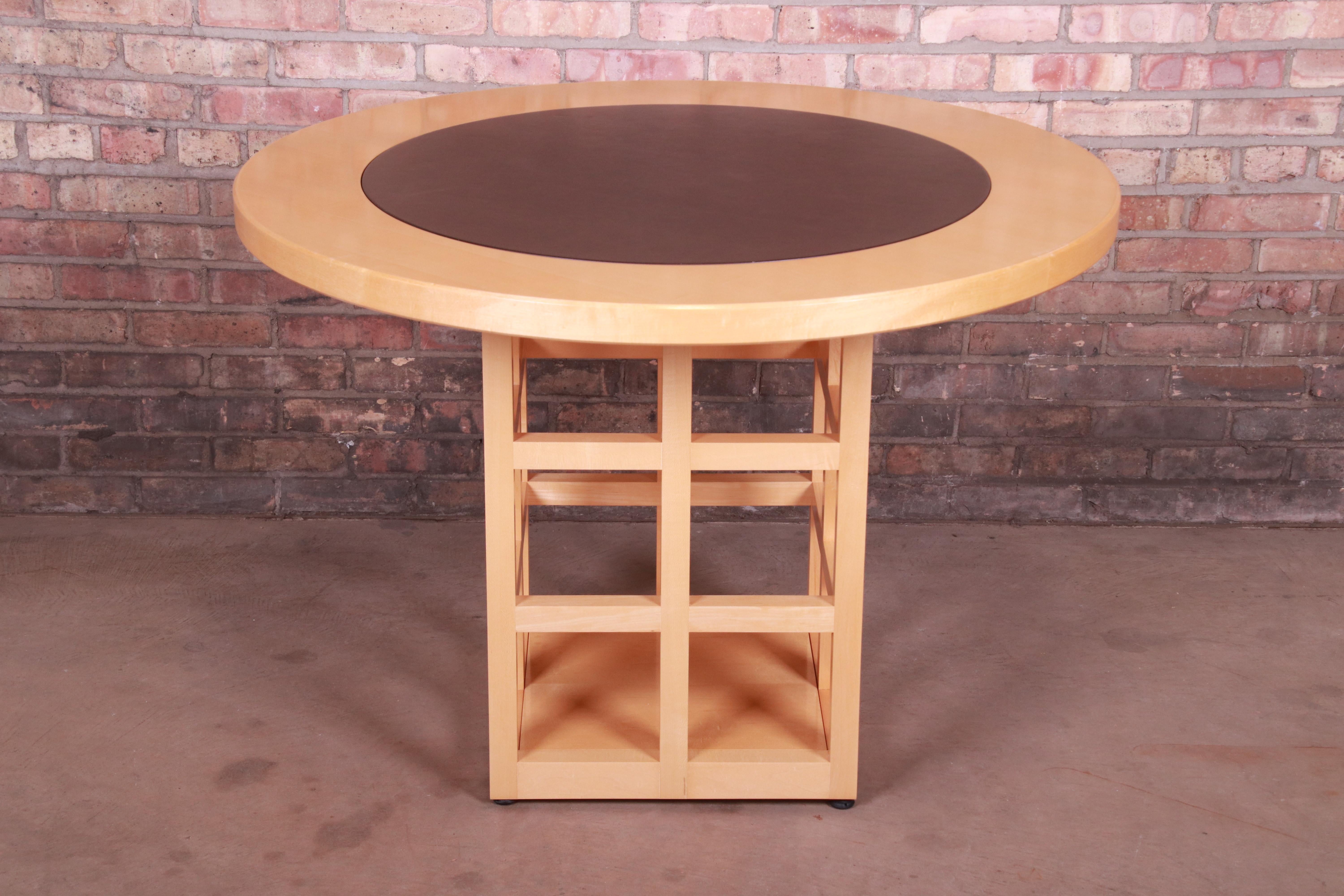 An exceptional modern dining table or game table

By Geiger-Brickel

USA, 1990s

Solid maple, with inset leather top and unique grid design pedestal.

Measures: 42