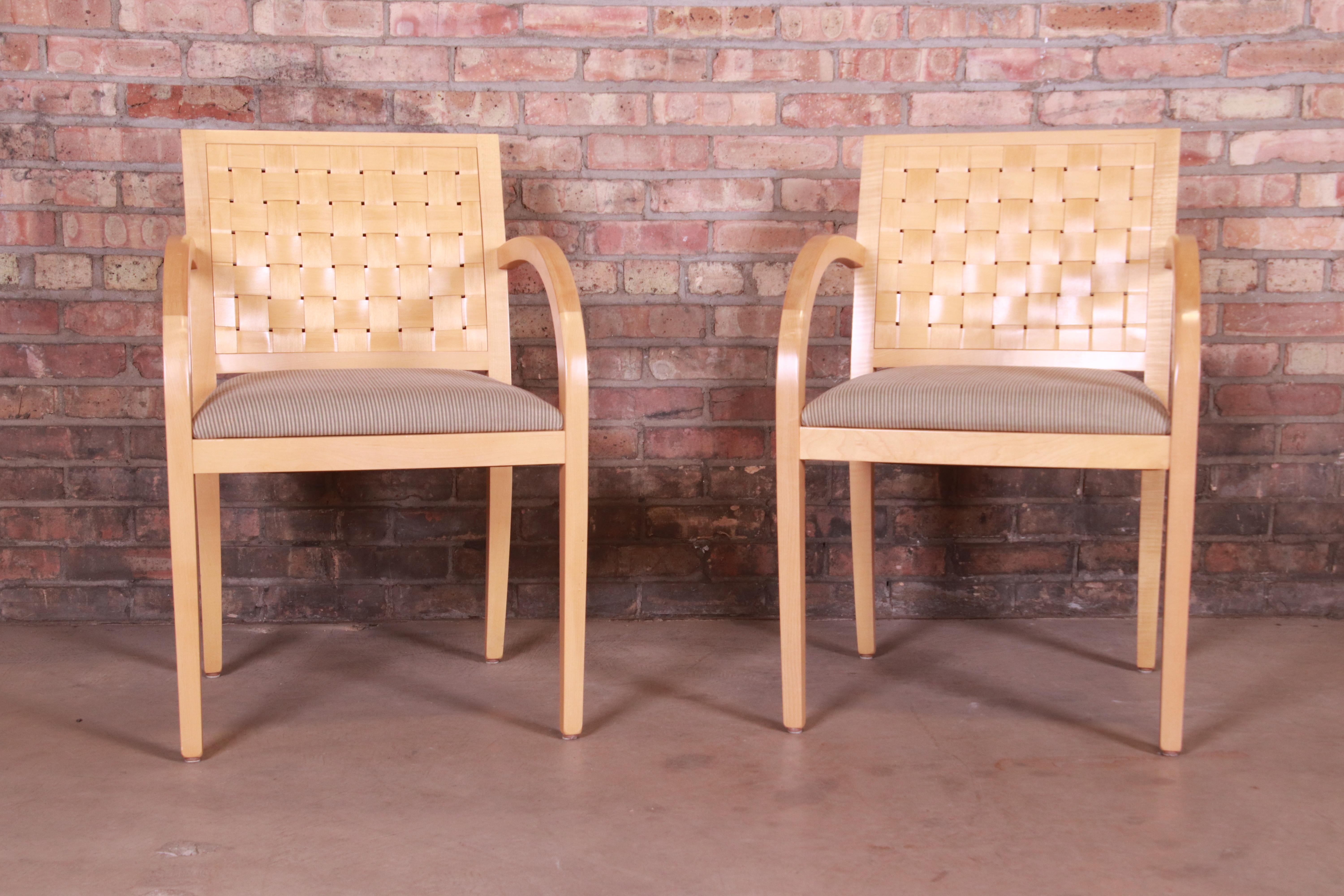 An exceptional pair of modern club chairs or dining armchairs

By Geiger-Brickel

USA, 1990s

Solid maple frames with woven backs, and striped sage green Donghia upholstered seats.

Measures: 22