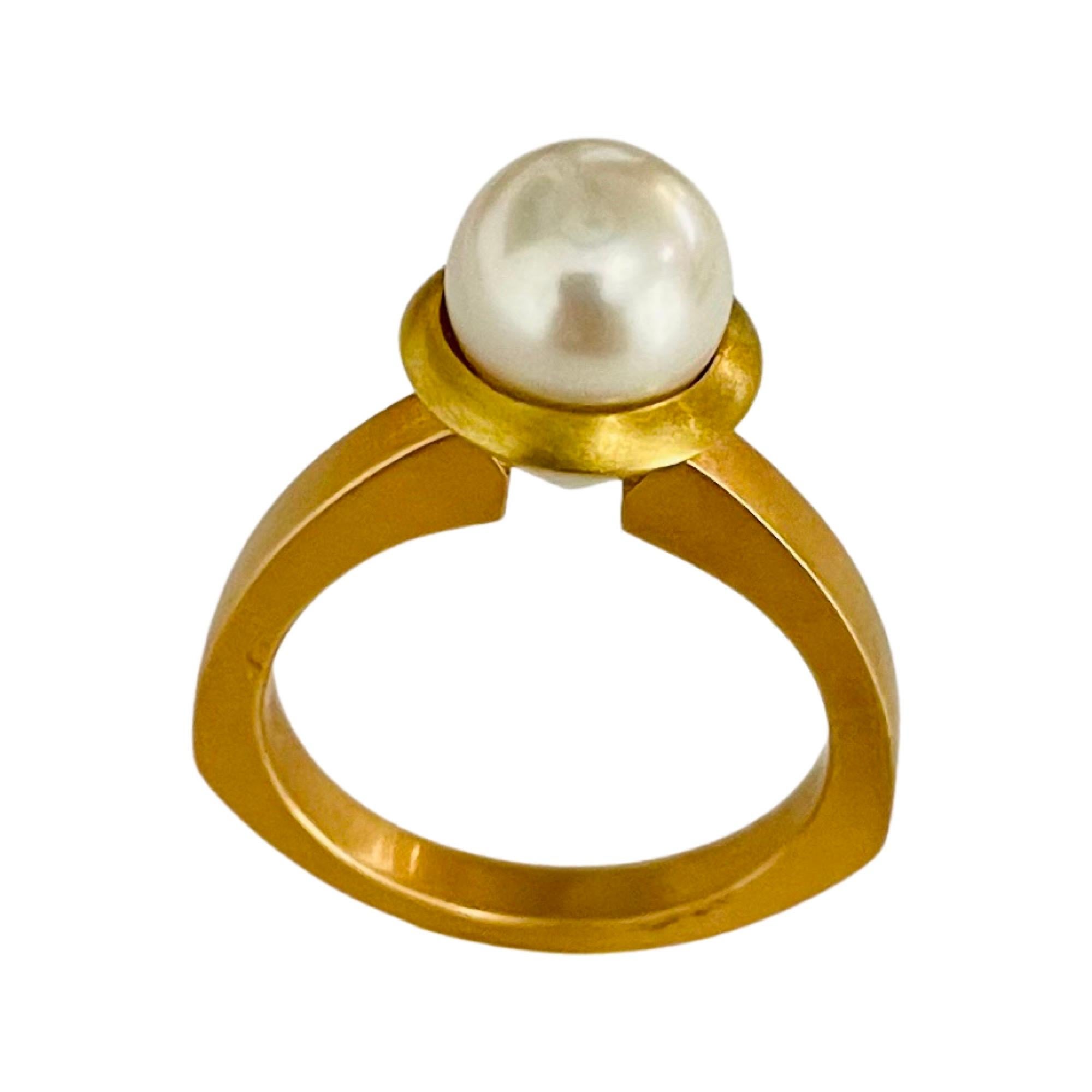 Gellner 18K Yellow and Rose Gold Cultured Japanese Akoya Pearl Ring. The Akoya Pearl is 7.7 mm. The pearl is round, with high luster, rose overtone and slight blemishes.  The ring is 9.5 mm at the top and tapers to 2.75 mm at the base of the shank. 