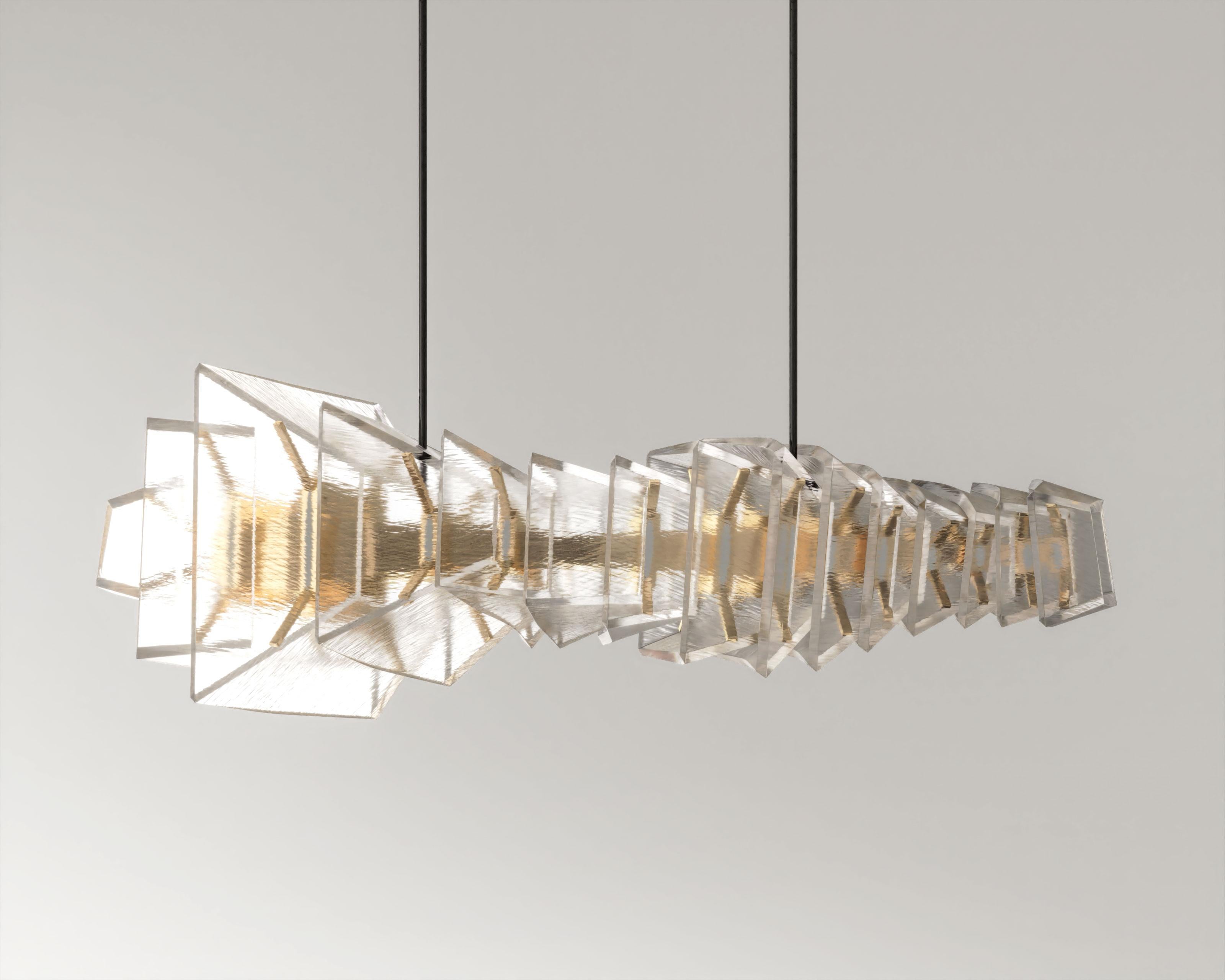 Gellus in Textured Glass
The Gelus Chandelier is a breathtaking masterpiece of artistry and craftsmanship, designed to illuminate your space with unparalleled elegance and sophistication. Inspired by the mesmerizing beauty of nested geometric
