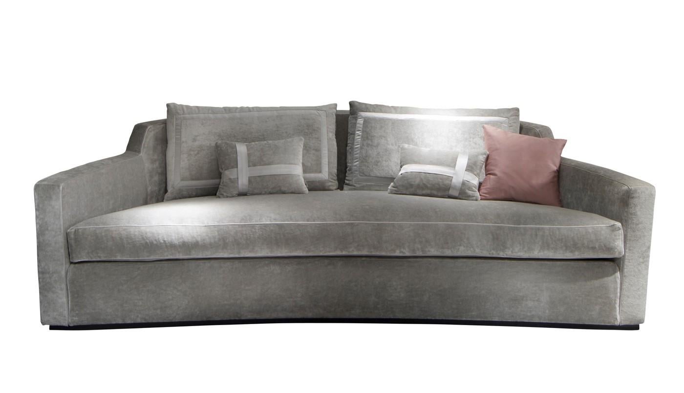 The unique silhouette of this elegant sofa combined with the plush seating offers a striking decorative accent and ample seating in a modern living room. The plywood structure is padded with multi-density polyurethane foam, creating a swooping