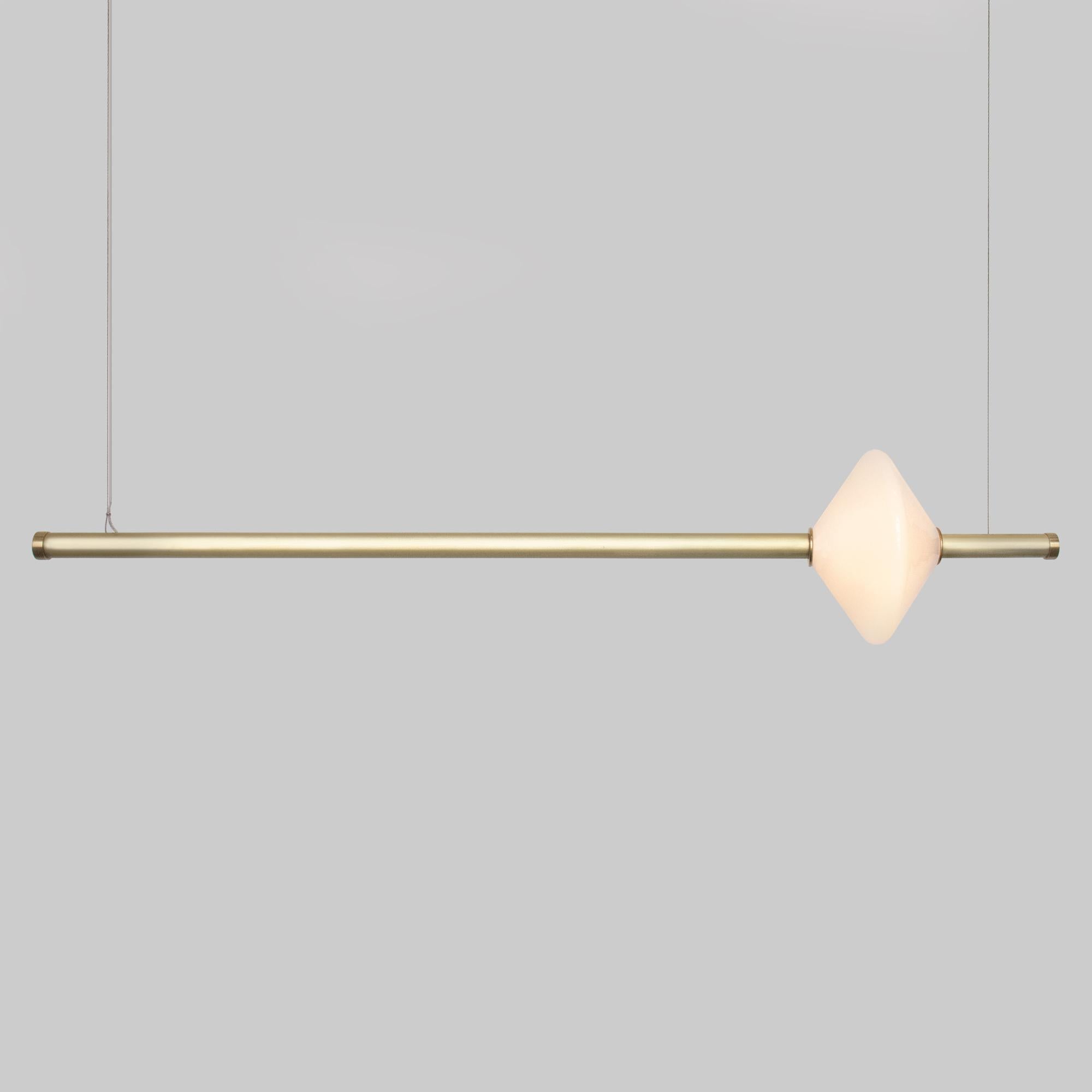The GEM 1 Linear Pendant is built of brass with an LED light source that is diffused by a hand-blown opal white glass diffuser. This pendant works as an individual fixture or can be installed in larger groupings to create a dynamic installation. Use
