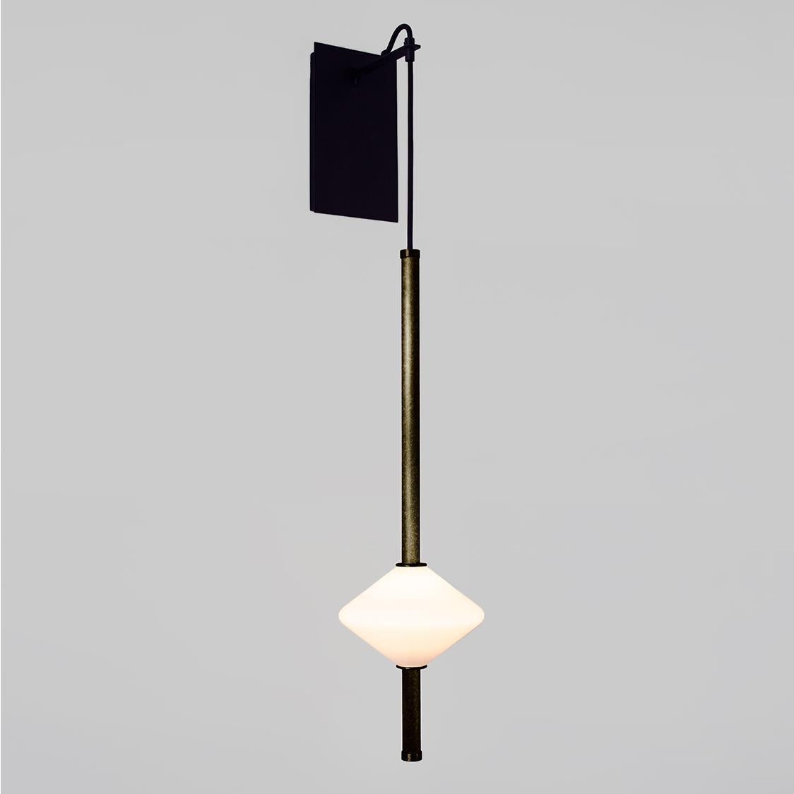 The GEM 1 Wall Sconce is built of brass with an LED light source that is diffused by a hand-blown opal white glass diffuser. Each wall sconce delicately projects a Gem diffuser with fittings made of brass tubing. The wall sconce features a
