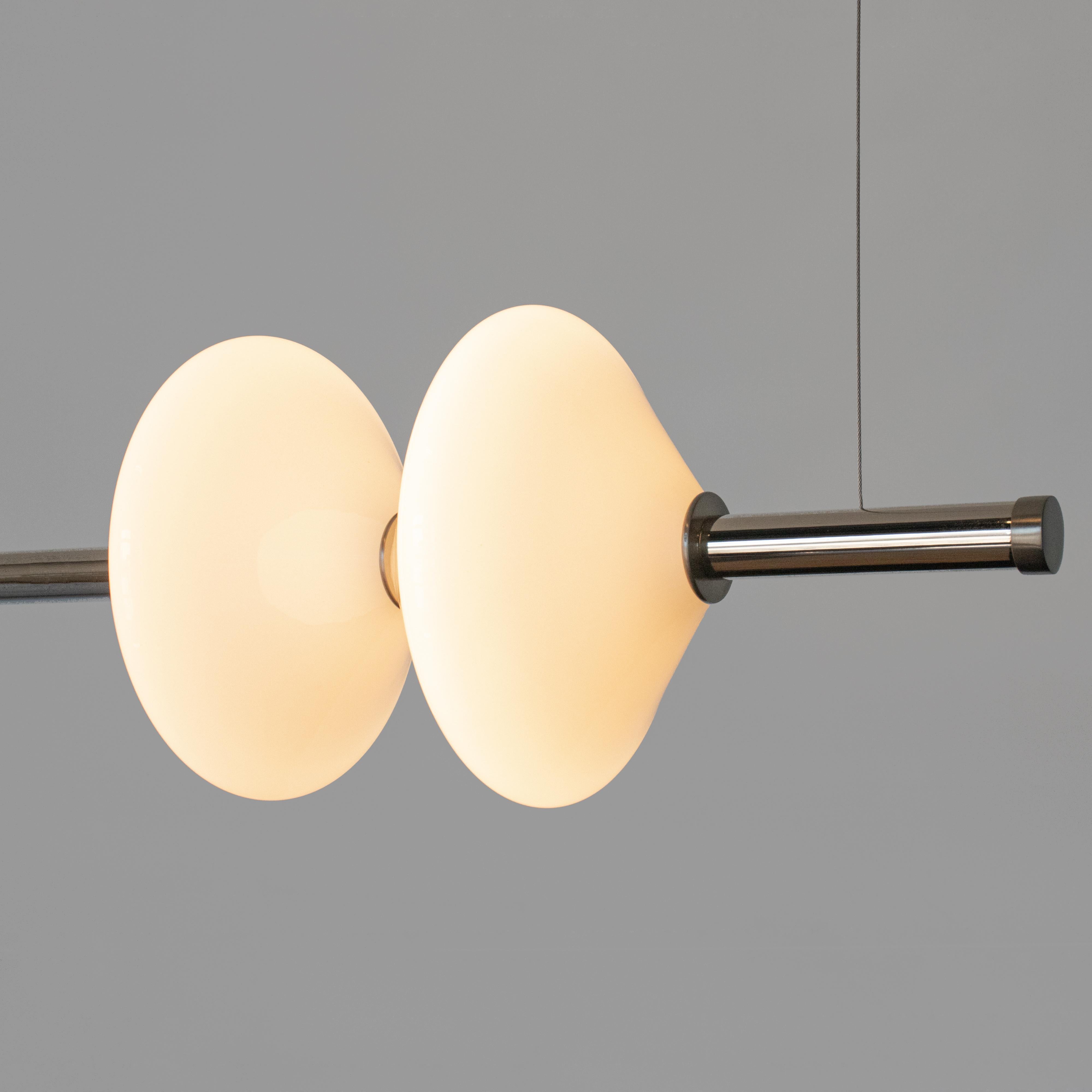 The GEM 2 linear pendant is built of brass with an LED light source that is diffused by a hand-blown opal white glass diffuser. This pendant works as an individual fixture or can be installed in larger groupings to create a dynamic installation. Use