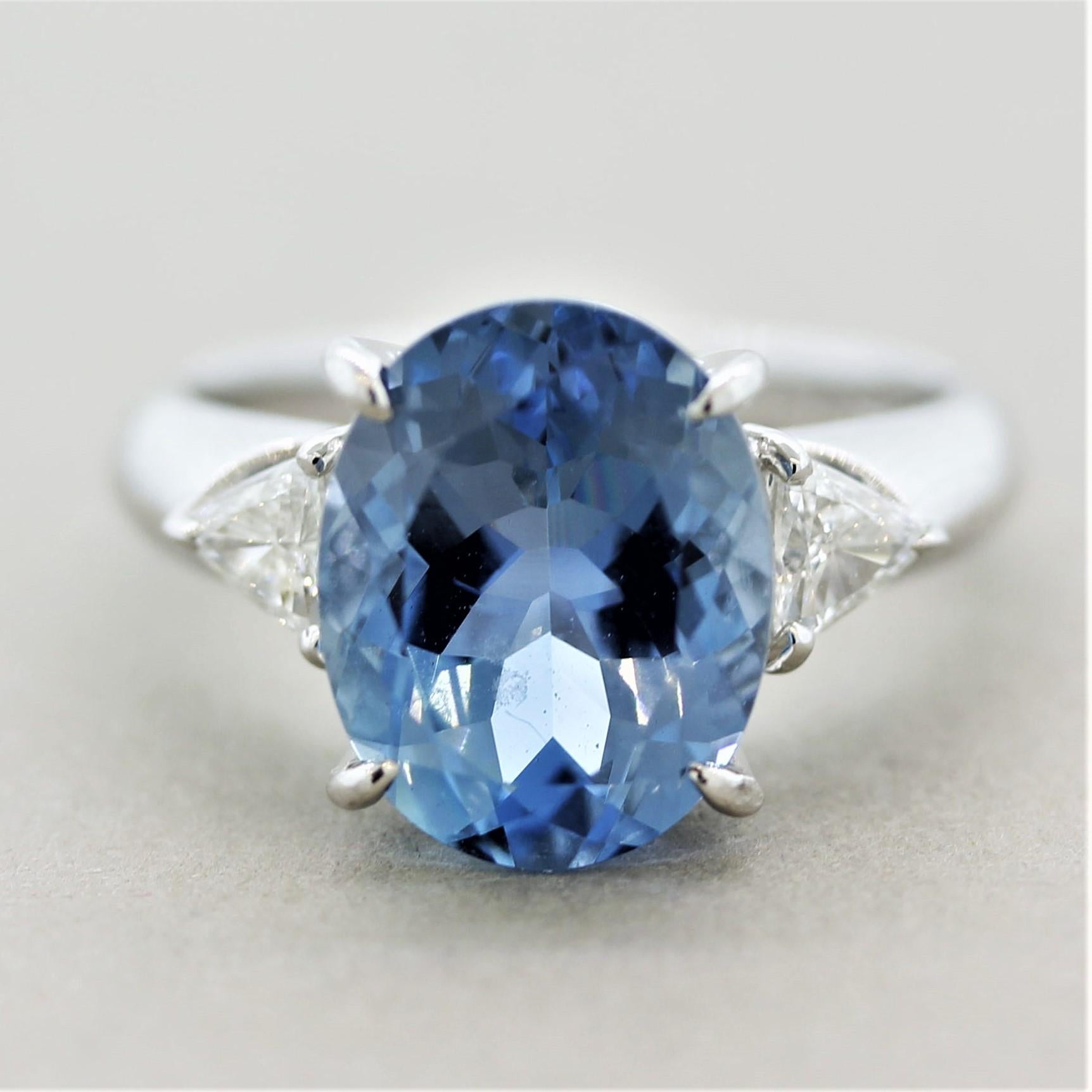 Truly one of the finest aquamarines we have seen! The gem weighs 3.69 carats and has the perfect deep sea-blue color. It is accented by 2 large trillion-cut diamonds set on its sides weighing a total of 0.21 carats. Hand-fabricated in platinum and