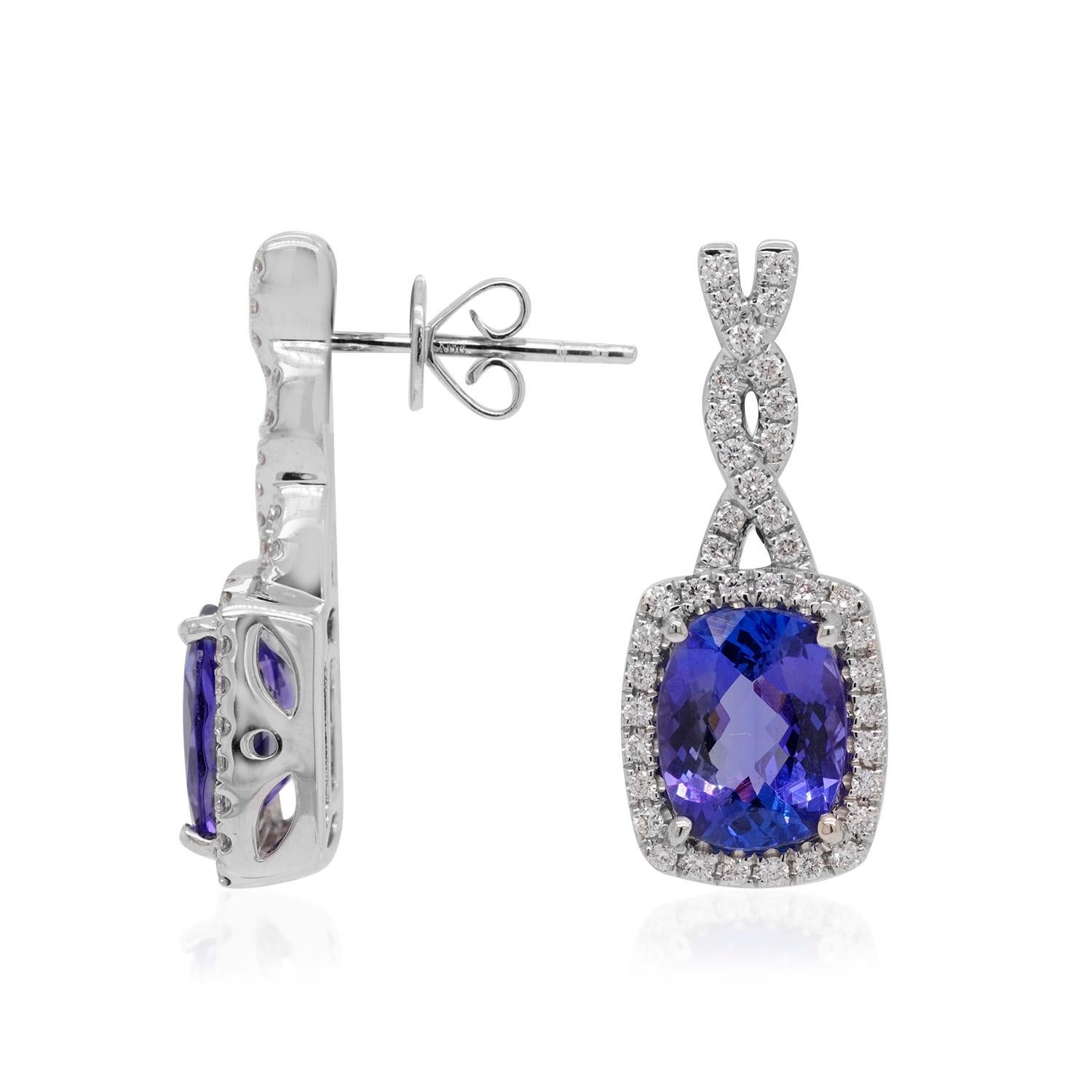 Crafted in 18K white gold, the impressive shine of these incredible earrings displays their fine craftsmanship with flair. Embellished with a cushion cut Tanzanite, highlights its deep color which adds a touch of drama to your apparel. Adorned with