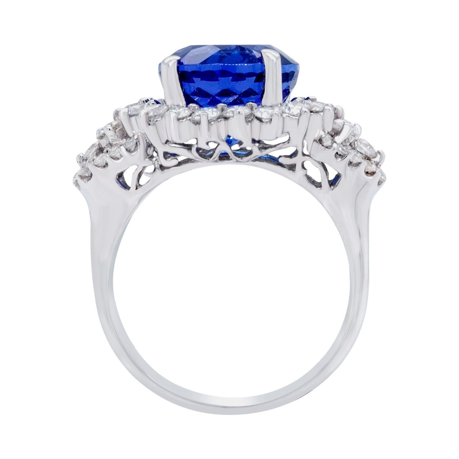 This striking ring is shaped to resemble the sun, with each and every facet of the ring branching outwards from the point of the stone outwards, like the rays of the sun. Set with a 5.90 ct Tanzanite and 0.99 carats of diamonds showcase the