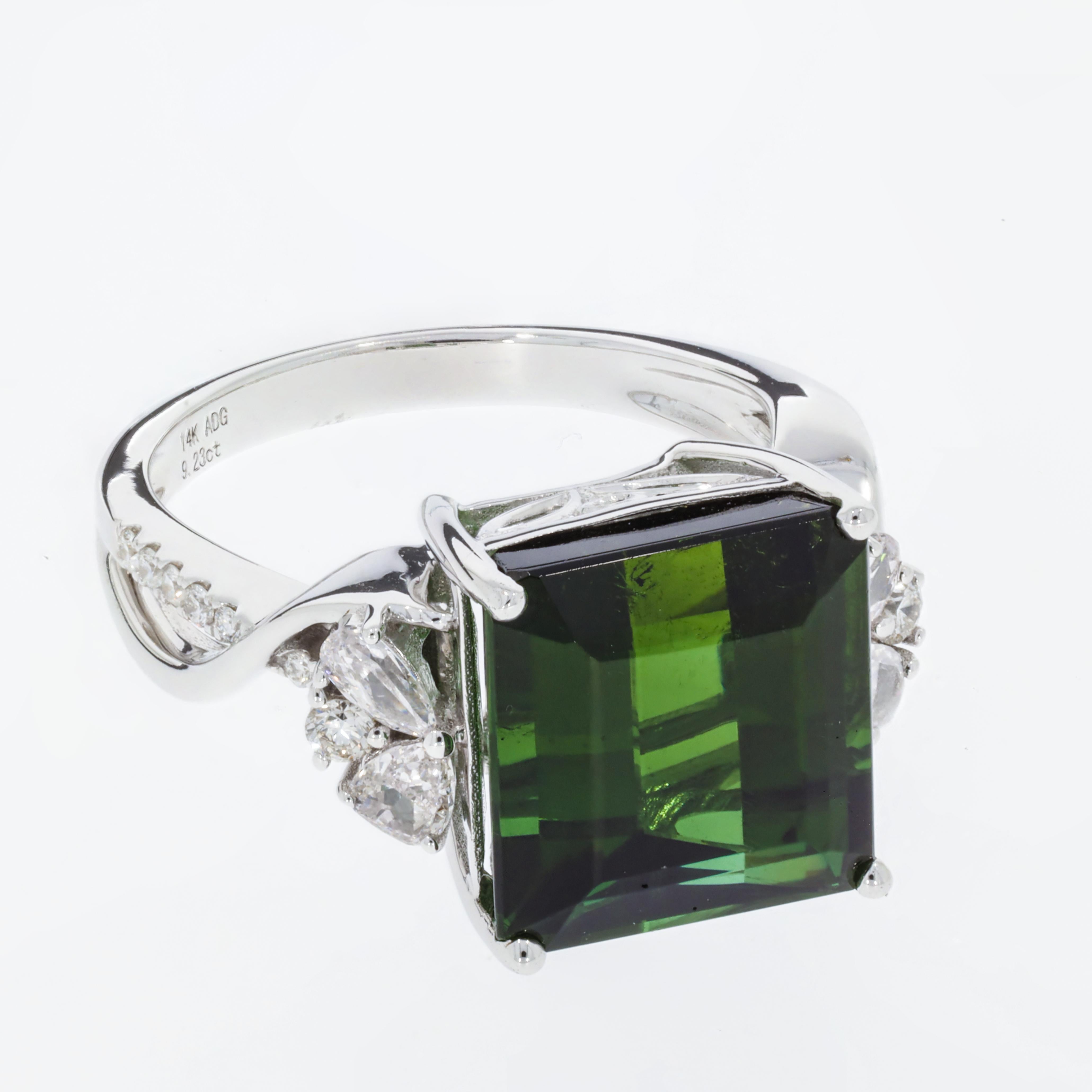 This classy piece would pair perfectly with everything in your wardrobe. Made with an exquisitely cut Emerald shape Green Tourmaline, this stone displays high clarity and is an excellent accessory. Accented with 0.48 ct of diamonds, this ring is an