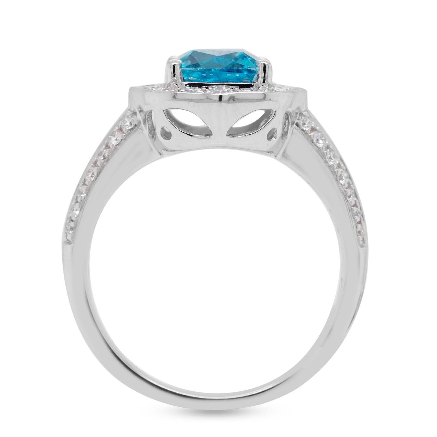 Designed with a marvelous Emerald cut Blue Zircon, the beauty of this gemstone leaves a lasting impression wherever you go. This captivating ring is further accentuated by the glittering round cut Diamonds which draw focus to its bright color.