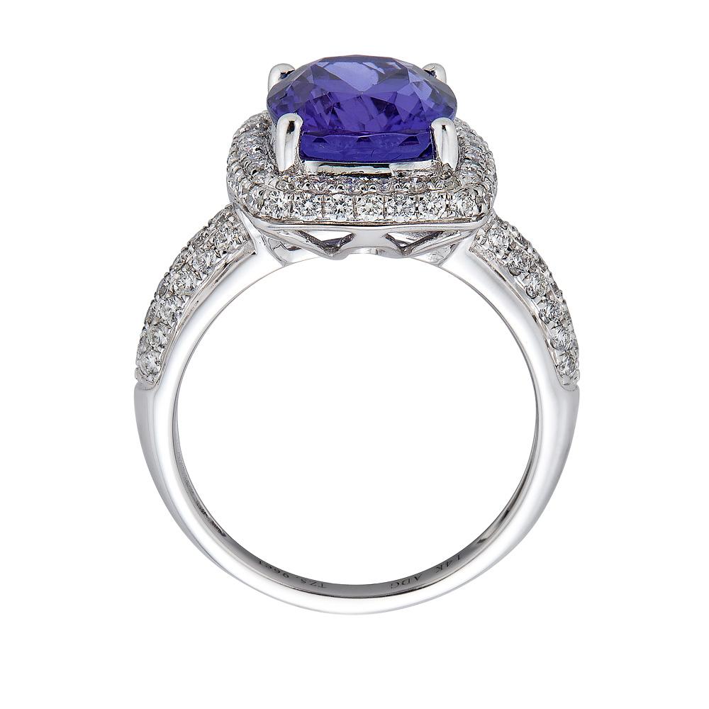 Crafted in 14K white gold, the artistic finish of this glorious ring enhances any attire instantly. Featuring a cushion-cut Tanzanite, this magnificent ring is accentuated by fine, round diamonds that are sure to leave you spellbound.

Tanzanite