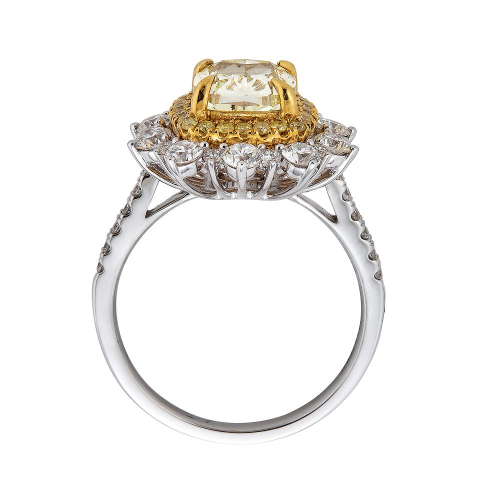 This majestic ring stands as a symbol of your success and pride, giving you the luxury you deserve. A cushion cut that showcases the glowing color of the Yellow Diamond, its true magic comes alive with the glimmer that the surrounding round diamonds