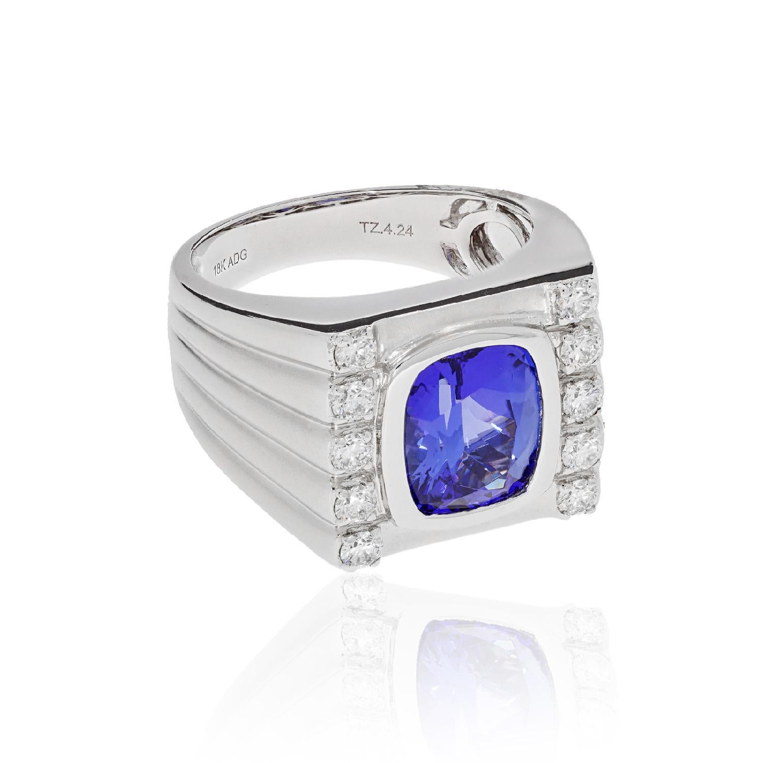 A stunning radiant design combined with the deep shade of Tanzanite gives this spectacular ring a dazzling finish. Accentuated further by round diamonds that add glamour, one glance at this marvelous ring and you are hooked. Created in 18K White