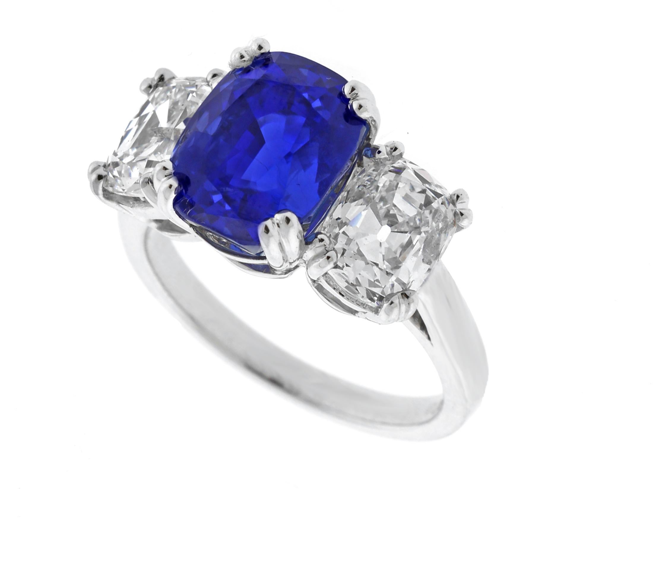 This exquisite piece represents a splendid marriage of craftsmanship, history, and the finest gemstones. It features an exceptional royal blue Burma Sapphire, weighing an impressive 5.72 carats, expertly cut into a cushion shape and certified by the