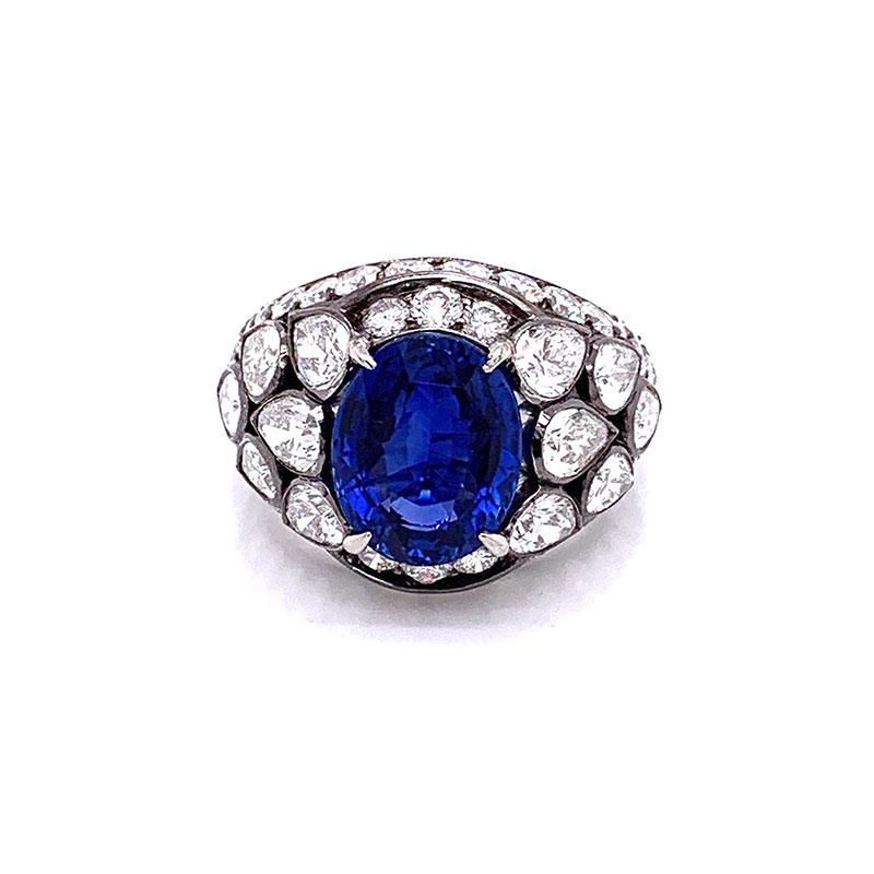 A superb true gem quality blue sapphire from Sri Lanka. Certified by the GIA, this oval shaped sapphire weighs 6.28 carats and has a natural vivid blue color. It is set in the most unique and sleek ring with 3 carats of pear and round cut diamonds