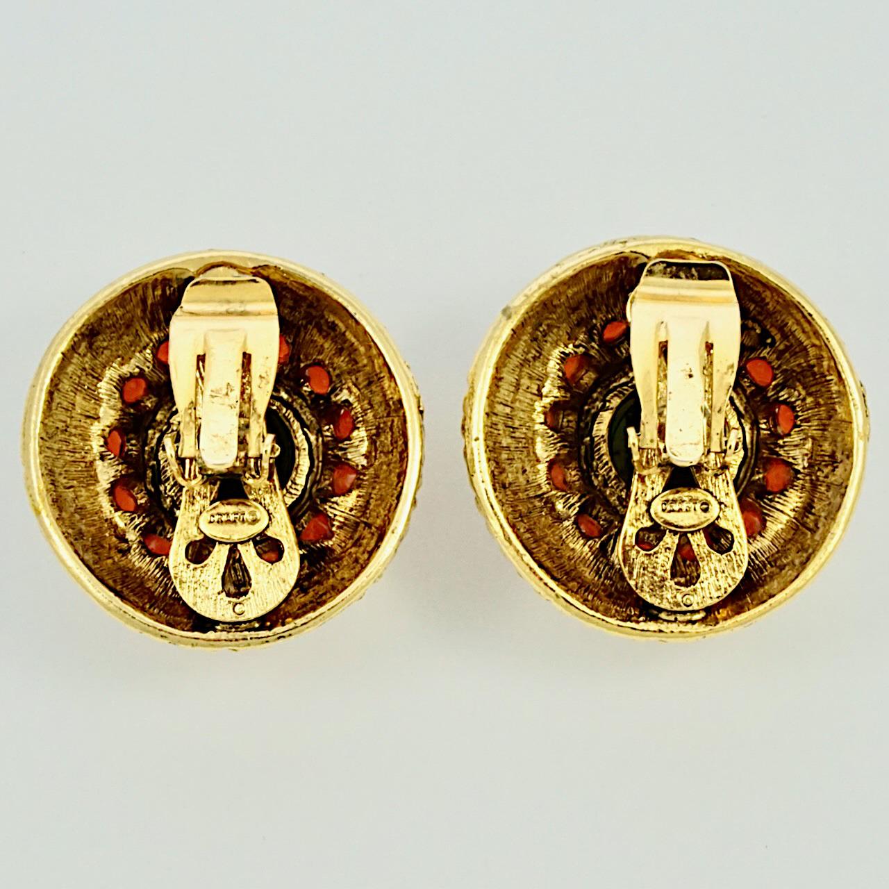 Gem-Craft signed Craft gold plated dome clip on earrings, decorated with mini gold domes, and featuring lovely black and burnt orange glass stones. Measuring diameter 3.35 cm / 1.3 inches.

This is a beautiful pair of designer earrings, circa 1980s. 