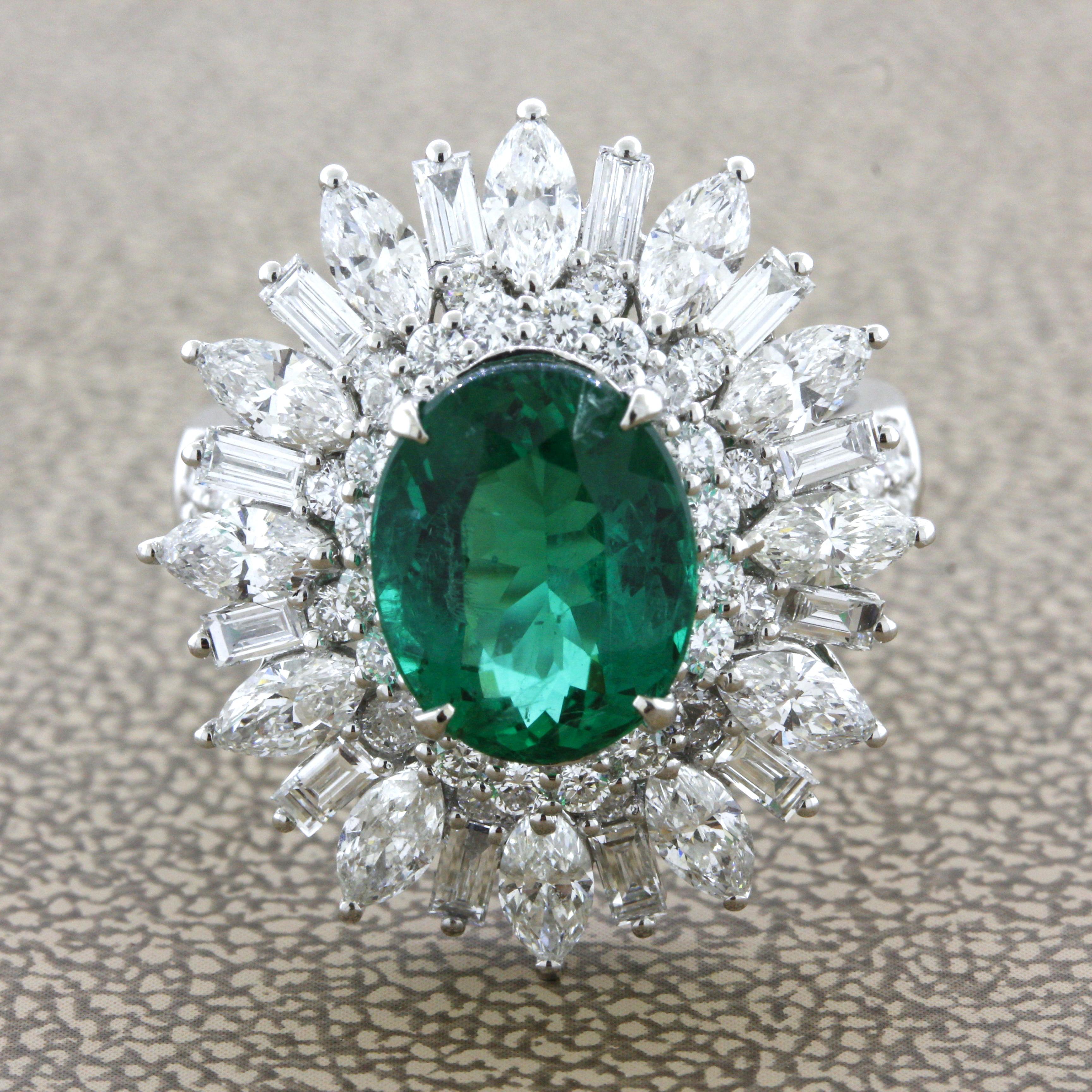 A superb top gem-quality emerald weighing 2.91 carats takes center stage of this diamond sunburst style ring. The grass green color of this fine gem is brilliant, vivid, rich, and bright all at the same time. You will love gazing into the stone and