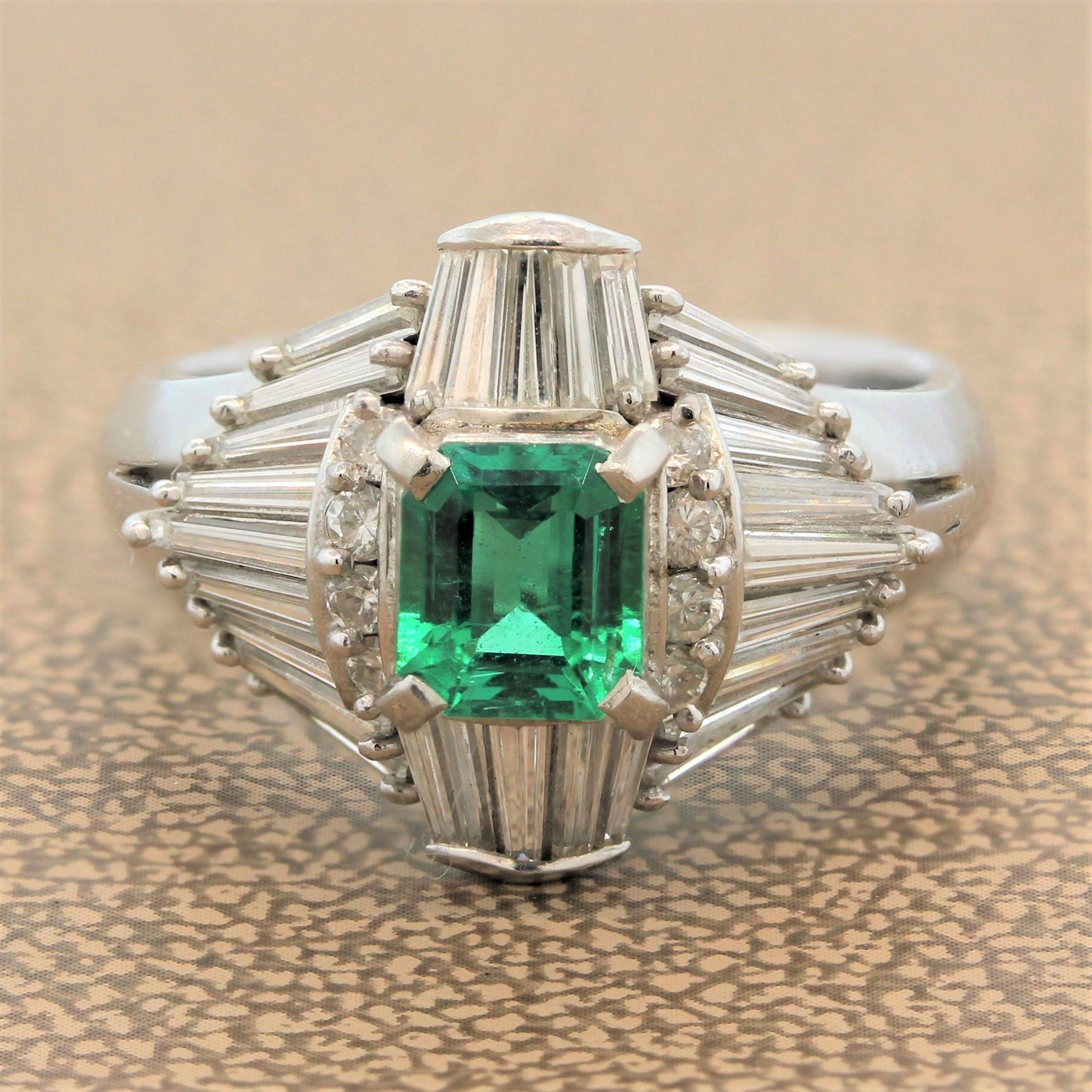 This ornate ring features a 0.68 carat emerald with a lush deep green color associated with the best stones from Colombia. The emerald cut emerald is enclosed by 1.03 carats of colorless baguette cut and round cut diamonds in a platinum