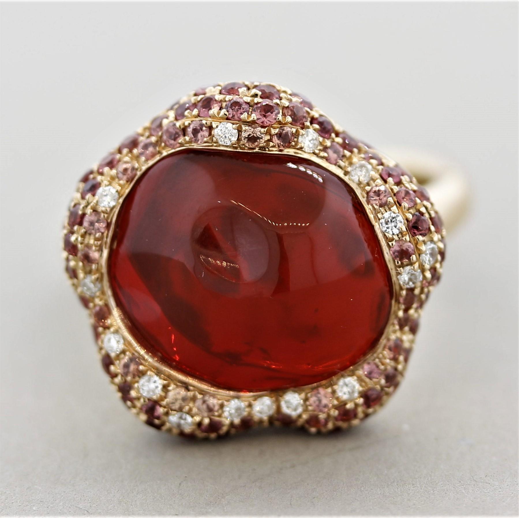 An absolute stunner! This ring features a 4.60 carat gem of a fire opal with an intense vivid orange/red color bested by no other. It is accented by 0.80 carats of round-cut orange sapphires and 0.09 carats of round brilliant-cut diamonds which