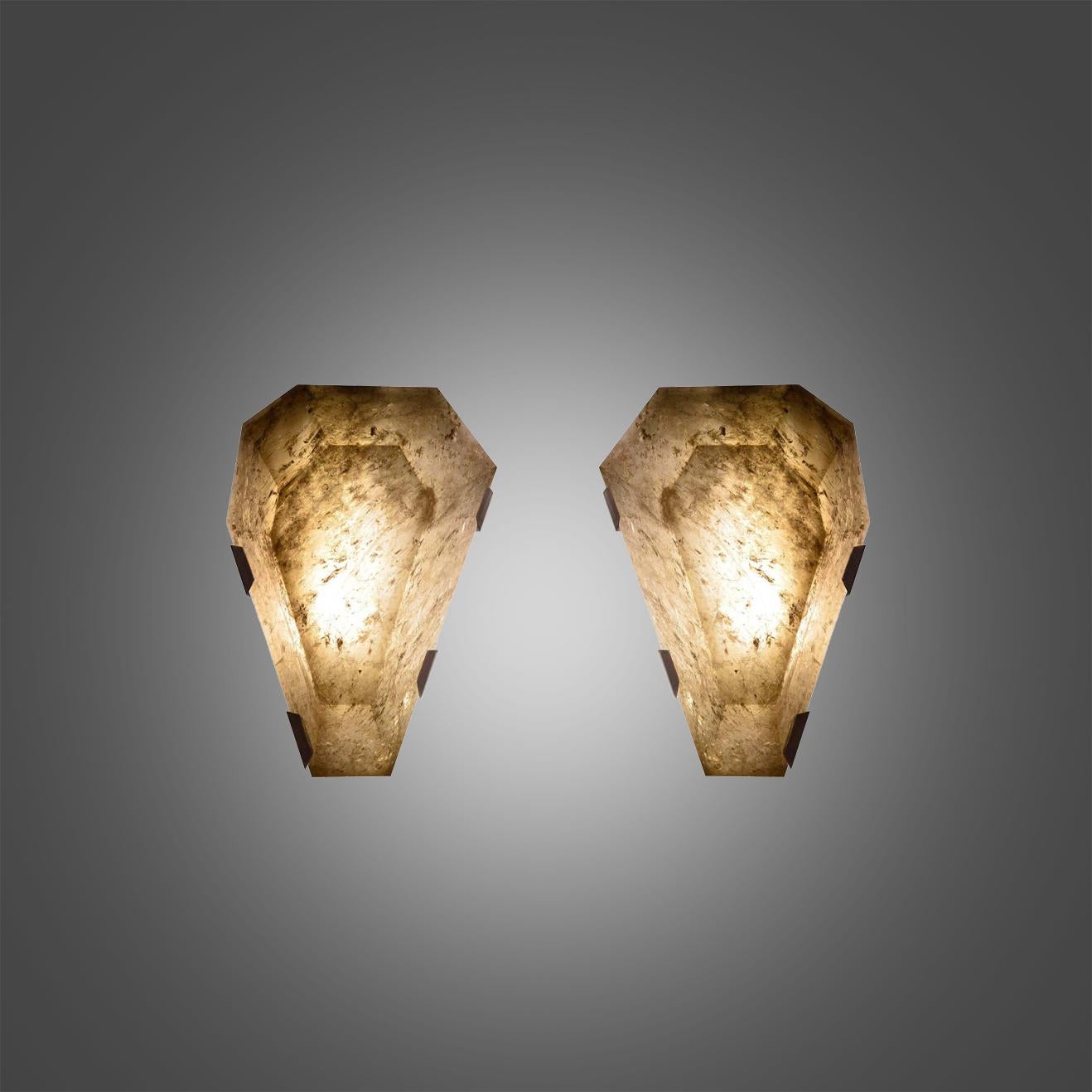 Pair of fine carved diamond form smoky rock crystal sconces with brass mounts. Created by Phoenix Gallery, NYC.
Each sconce installed two sockets, use candelabra lightbulbs, 120W total
Custom size and metal finish upon request.