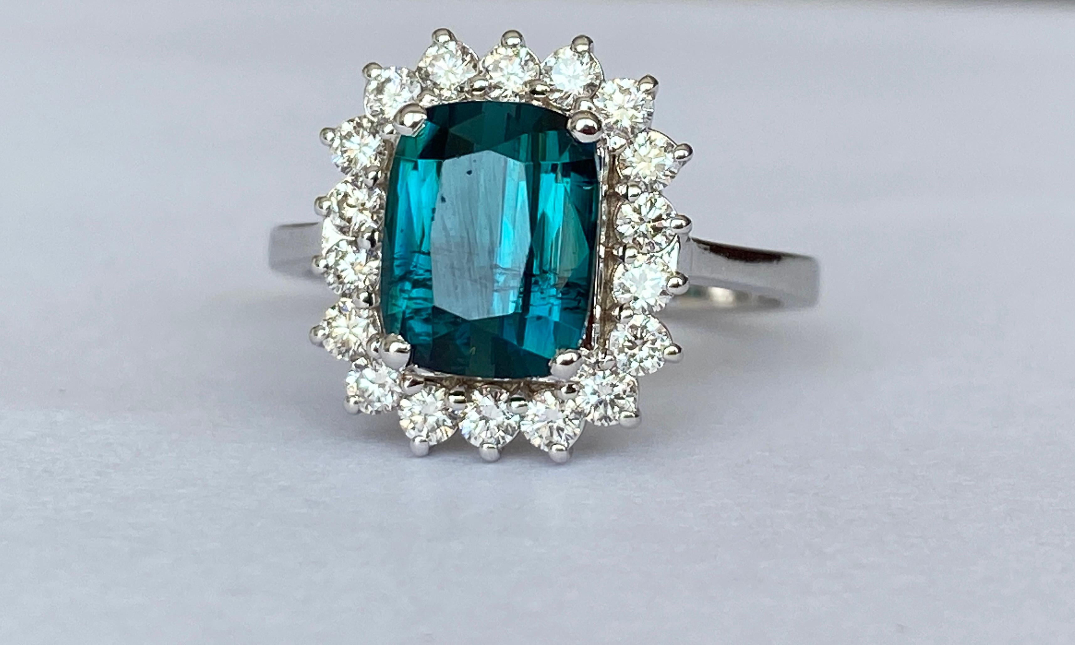 Exclusive handmade ring in 18 kt white gold set with  cushion mixed cut lagoon tourmaline of 2.00 carats and decorated with 18 pieces of brilliant cut diamonds. Total diamonds:0.54 ct E/F/VS. GEM Report Antwerp certificate is included. Number