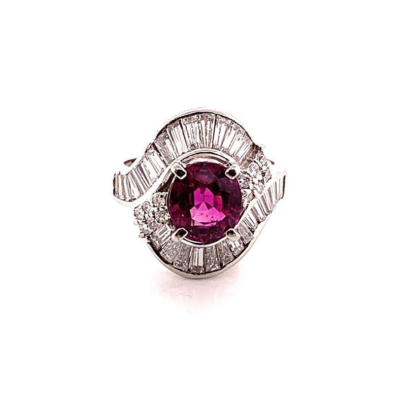 An absolute spectacular ring featuring a true gem of a ruby weighting in at 2.22 carats. Cut as an oval shape the ruby has an intense vivid pinkish-red color. It is also eye clean with no inclusions. The specular ruby is complemented by 1.37 carats