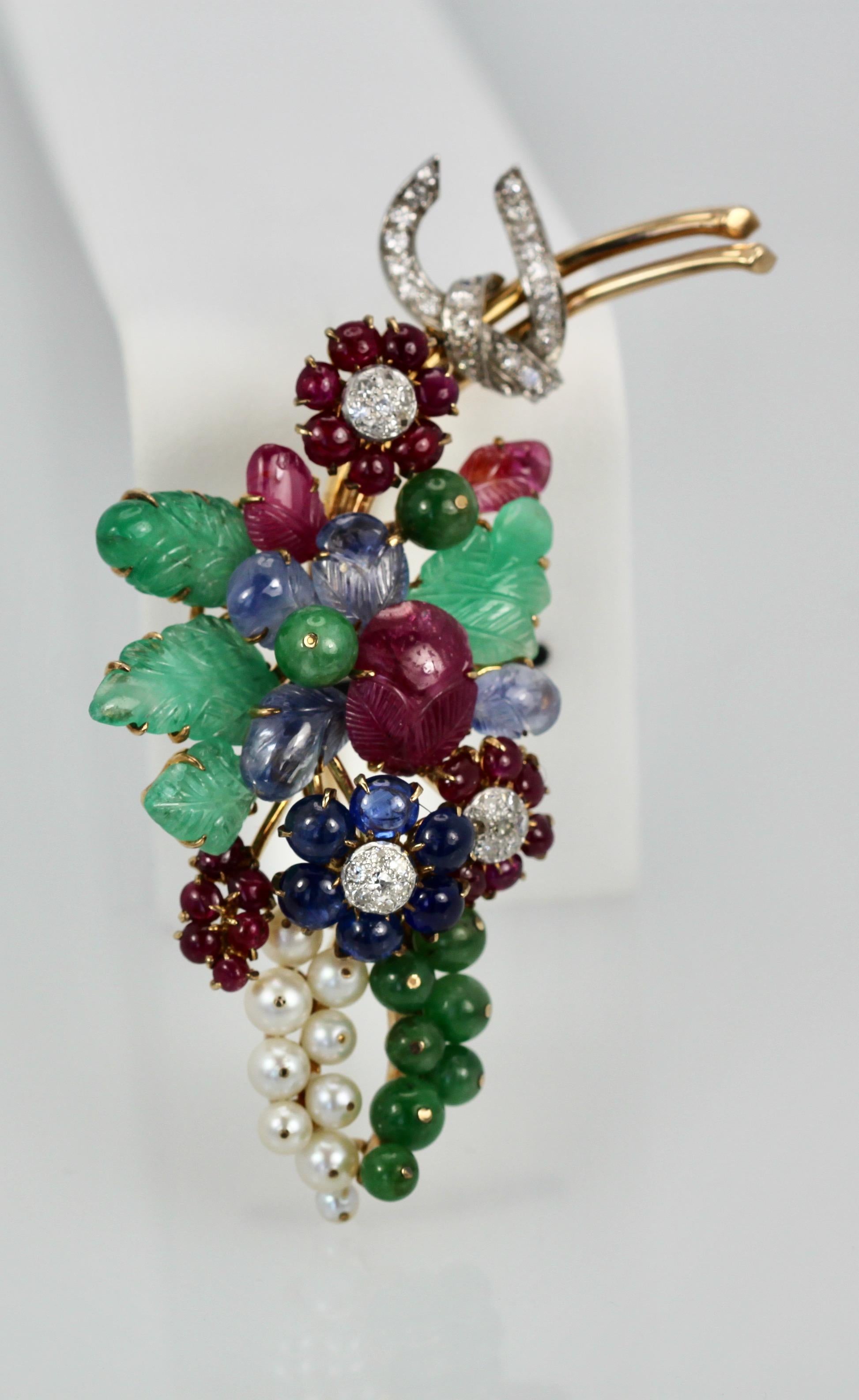 This gorgeous gem set Diamond brooch is a bit Tutti Frutti plus.  This brooch is large 8.5 cm long or 3 1/4