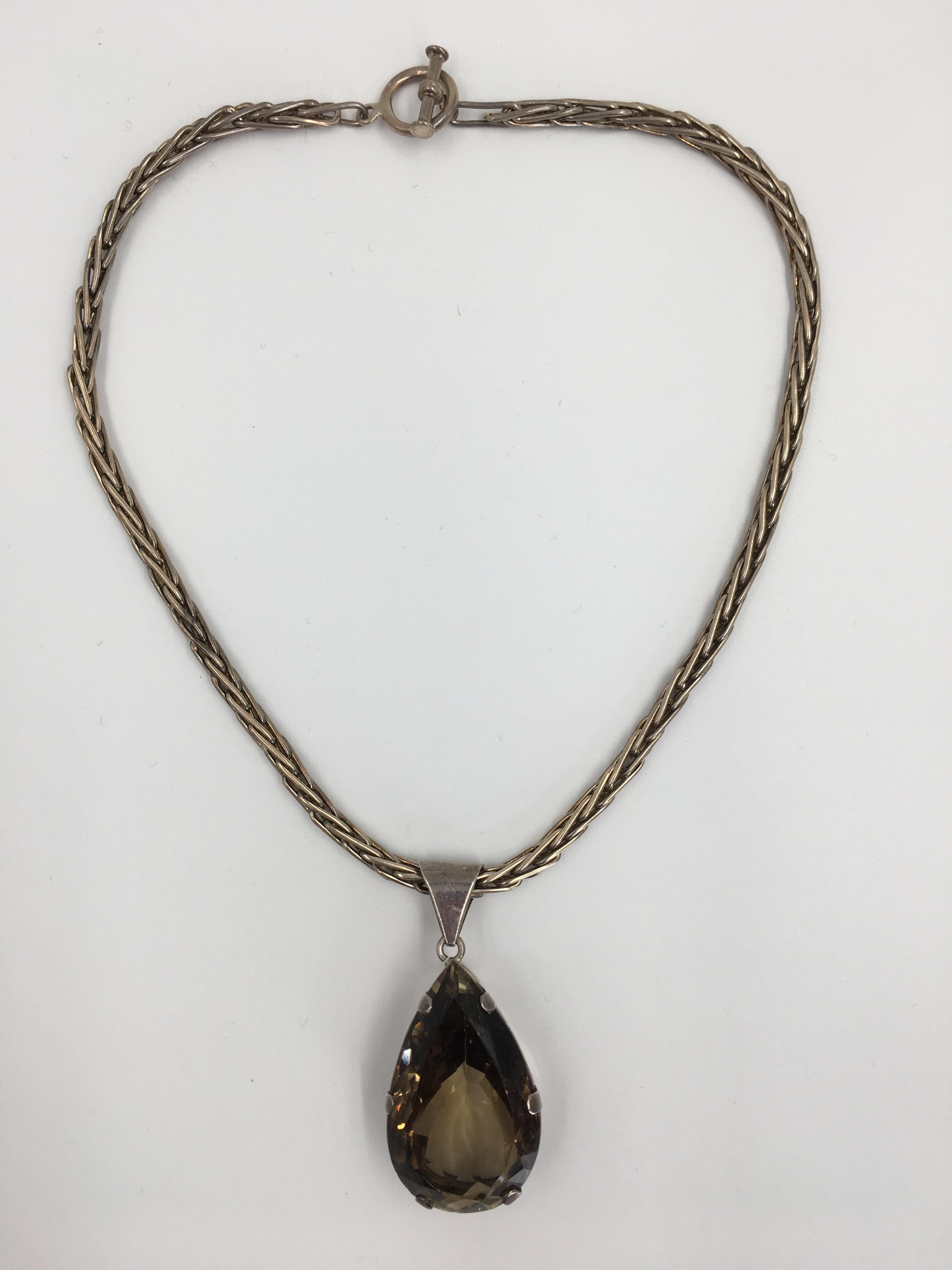 Gem Set Faceted Topaz and Sterling Silver Artisan Necklace with Sterling Silver Foxtail Chain. Sterling Silver 925 stamped. Stamped Mexico on the Chain.
In very good vintage condition.

Measurements are as follows:

Neck drop (from back neck to