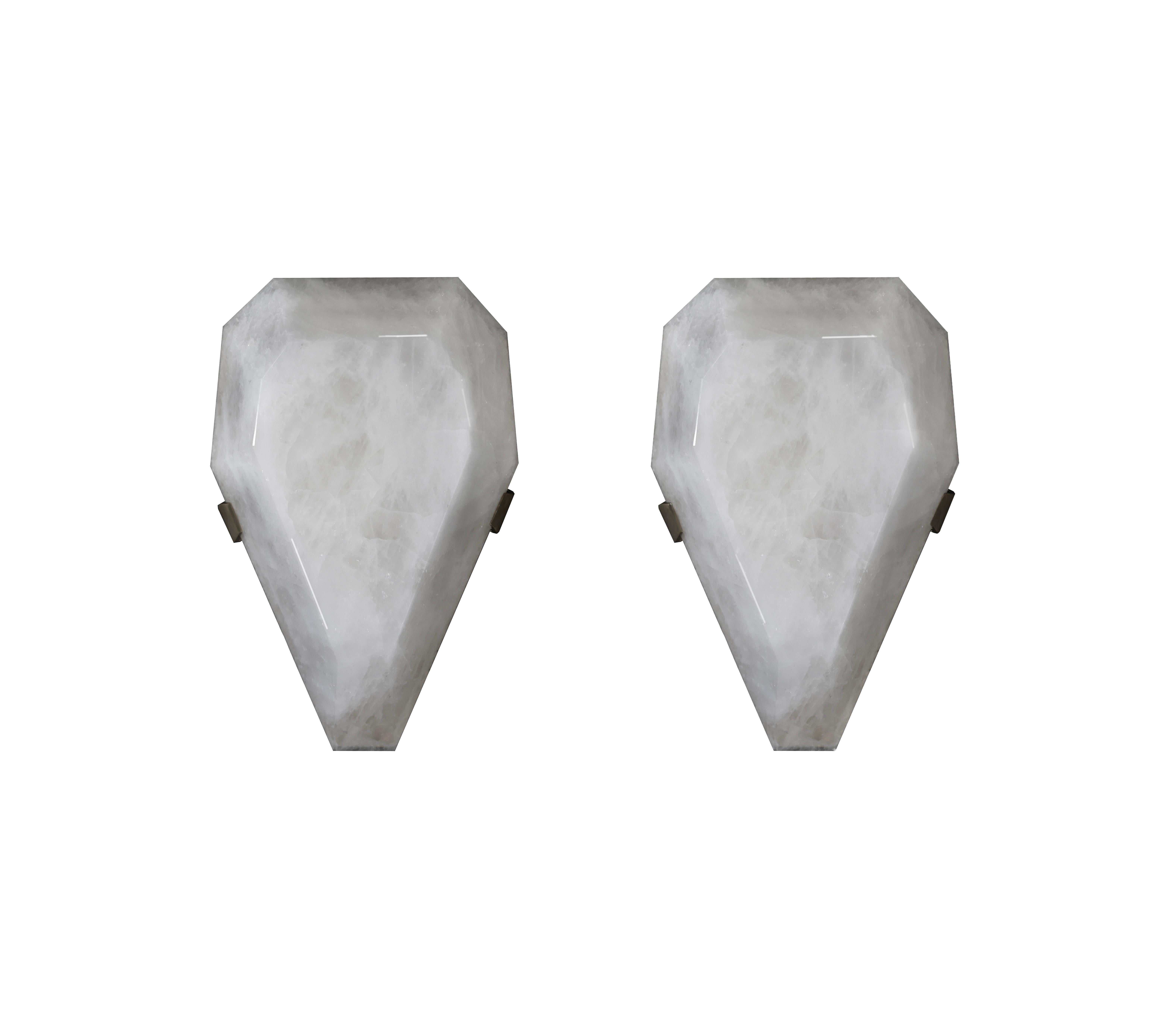 Pair of fine carved diamond form rock crystal sconces with antique brass mounts. Created by Phoenix Gallery, NYC.
Each sconce installed two sockets, use candelabra lightbulbs, 120W total
Custom size and metal finish upon request.
