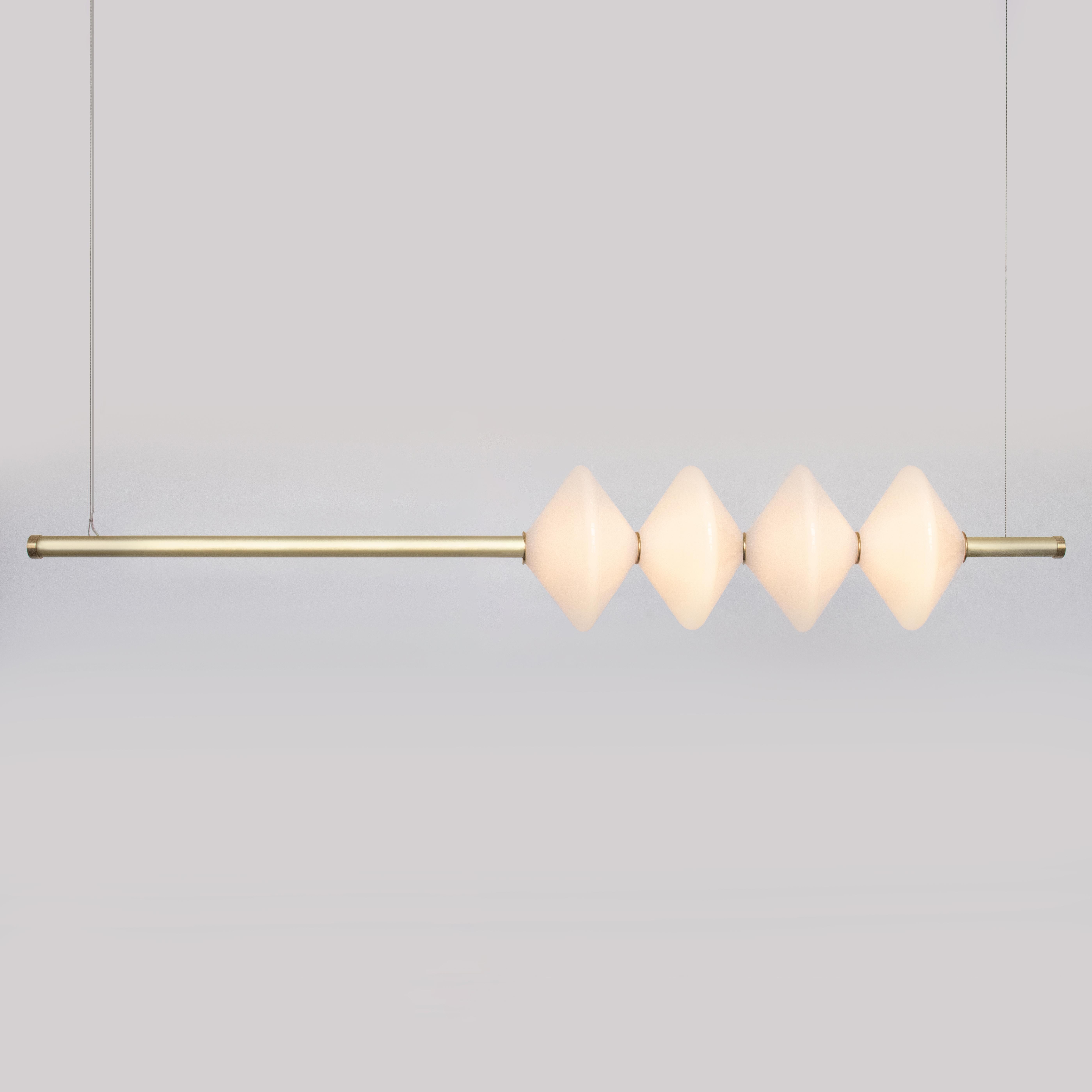 GEM4 PENDANT - LINEAR

The GEM4 Pendant is built of brass with an LED light source that is diffused by a hand-blown glass diffusers. This pendant works as an individual fixture or can be installed in larger groupings to create a dynamic
