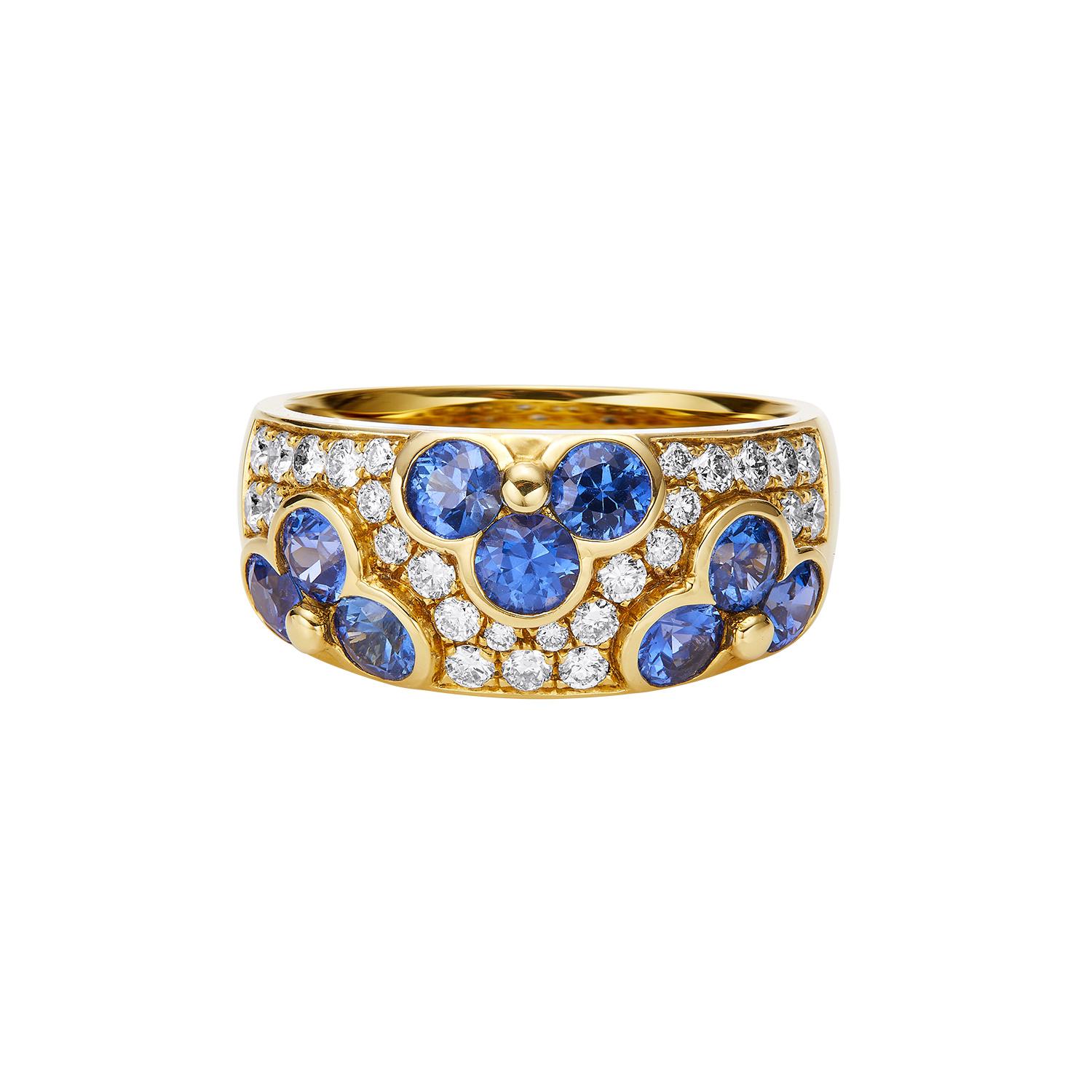 Expertly crafted by GEMCOOK, this 18k yellow gold ring is adorned with a beautiful sapphire flower design. With its wide band and high-quality materials, this ring is a timeless addition to any jewelry collection. Enjoy the elegance and luxury of