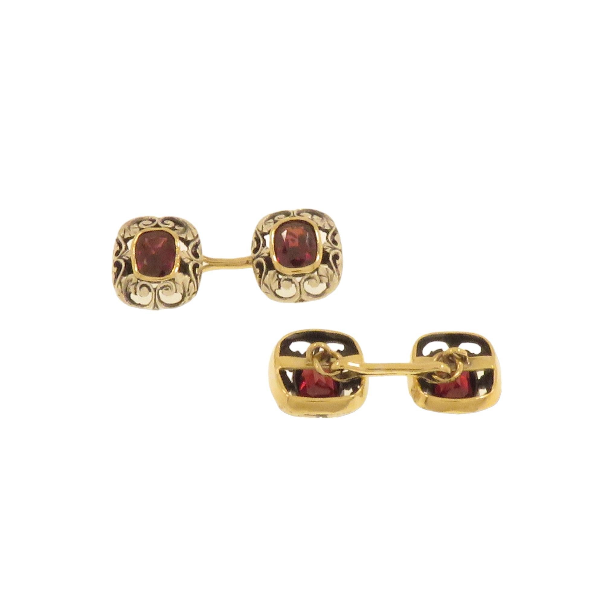 Handmade antique cufflinks, 14k rose gold for the lower part and pierced and engraved silver for the upper part with a cushion-cut garnet set in the center. They are made in the early 20th century when silver was used as the white metal as white