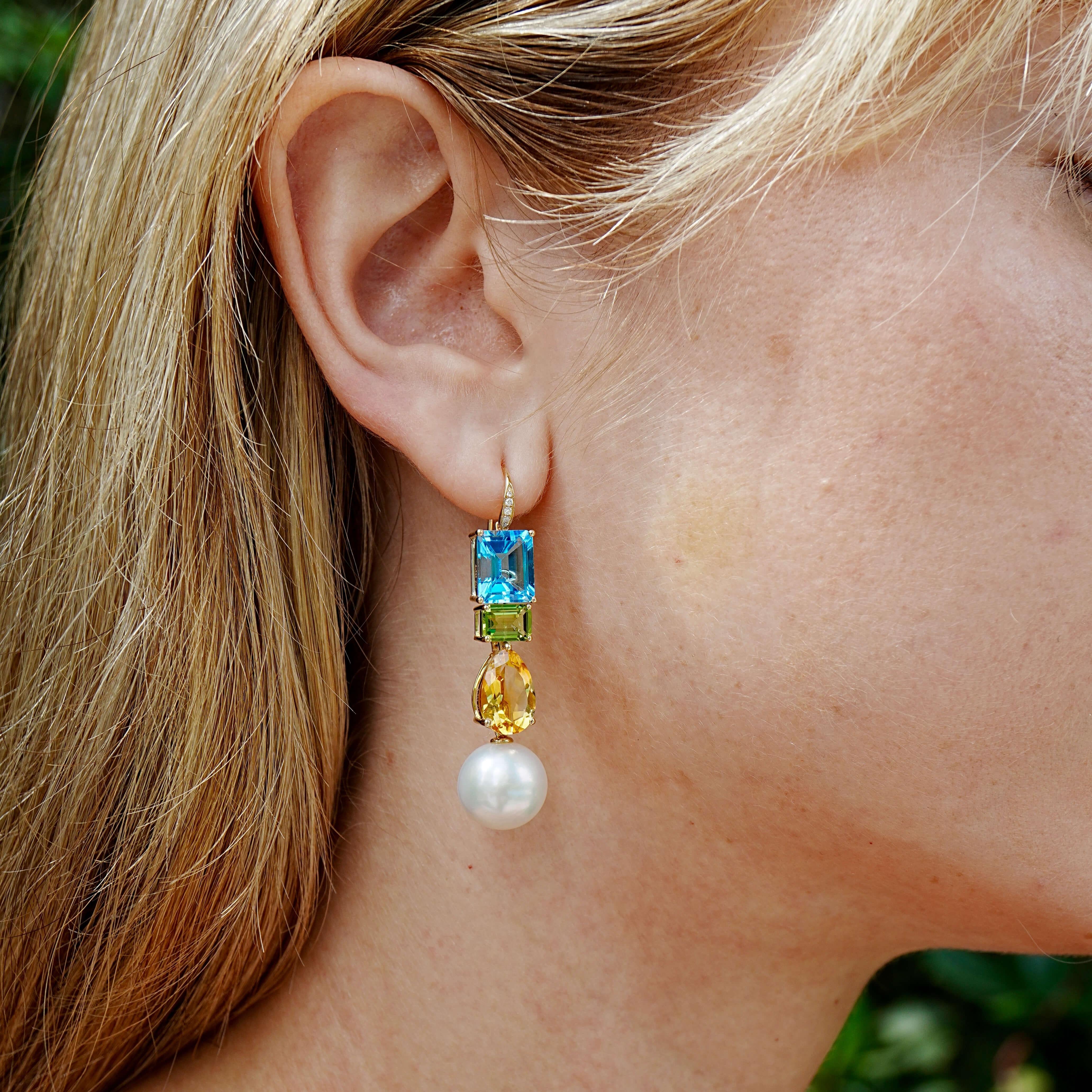 A symphony of color and craftsmanship, these GemFusion earrings combine Swiss blue topaz, golden citrine, and vivid green peridot — each gemstone faceted to capture light from every angle. Accented with fine diamonds and set in 14K solid gold, the
