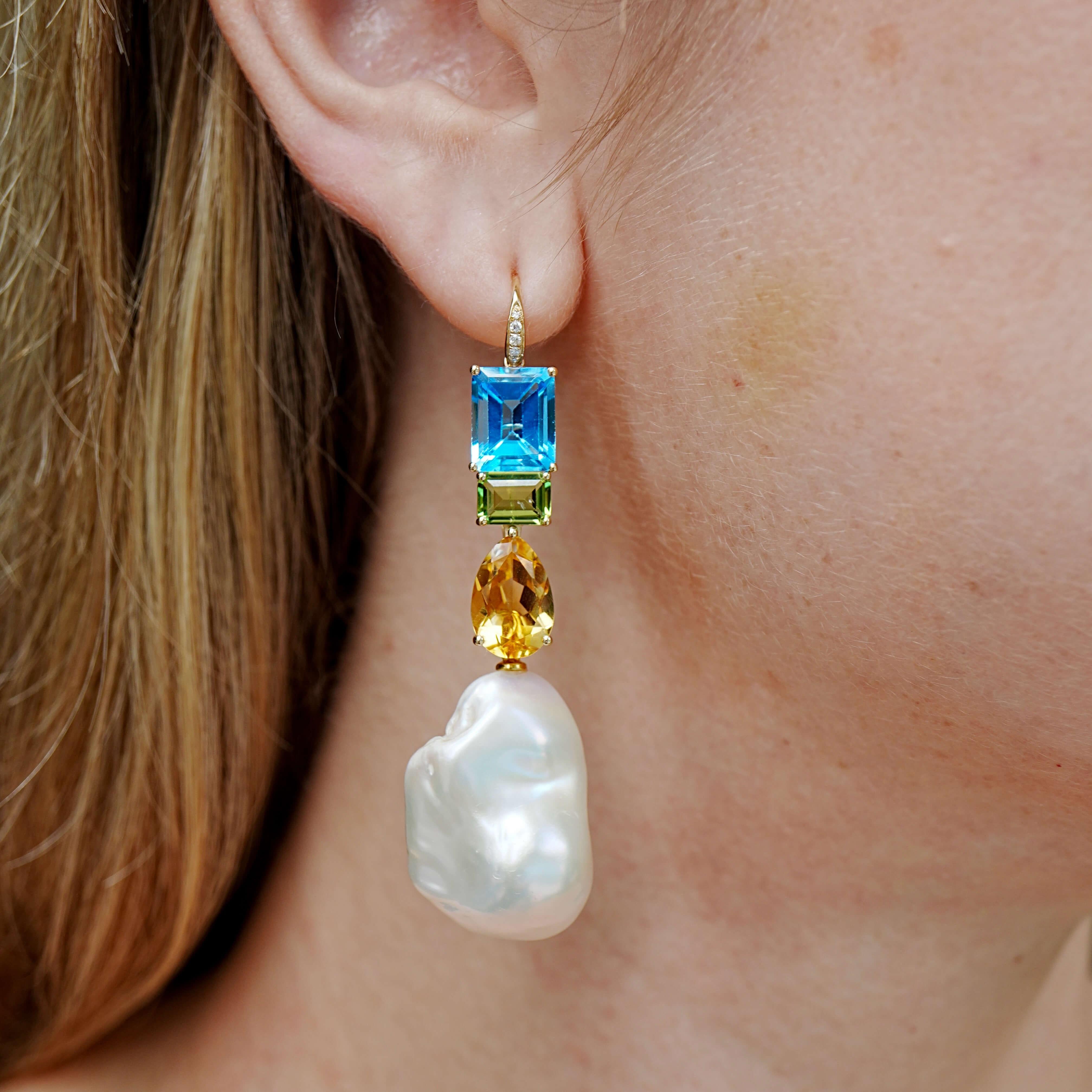 A celebration of color, movement, and creative styling—these convertible drop earrings from Kai Fine Jewelry’s GemFusion series feature a joyful fusion of natural gemstones. Vibrant emerald-cut blue topaz & green peridot and golden citrine with big