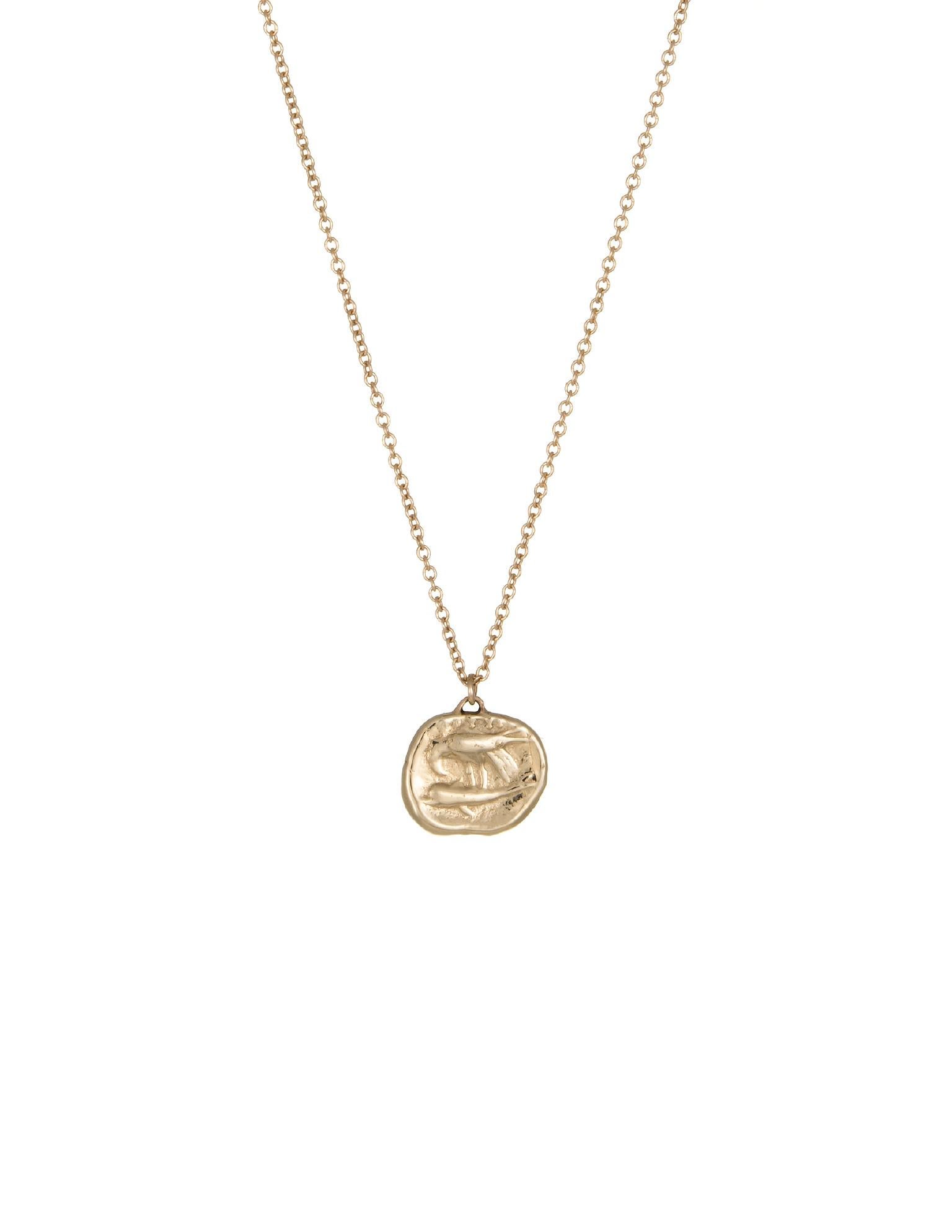 Our Gemini pendant in 14k gold. Molded from an ancient Greek coin. In Greek Myth, Castor and Pollux (sons of Zeus and Leda) were known as the Gemini. They protected travelers and sailors, and were known to intervene during times of crisis. Opposite