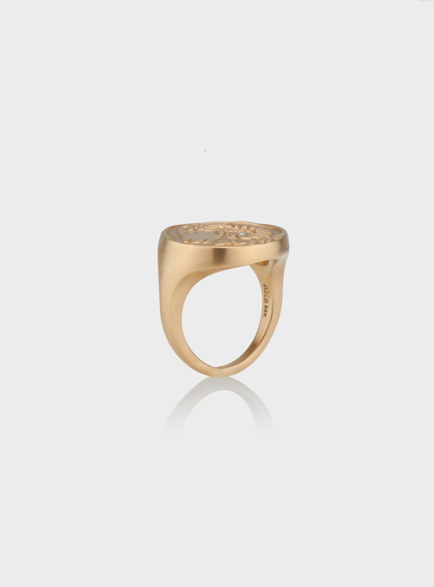 Cast from wax, hand-carved by designer Susan Highsmith, this ring is exquisitely designed, made, and finished.

It has a round, coin-like face, carved in relief to show twin girls facing each other, with a matching braid acting like a garland motif