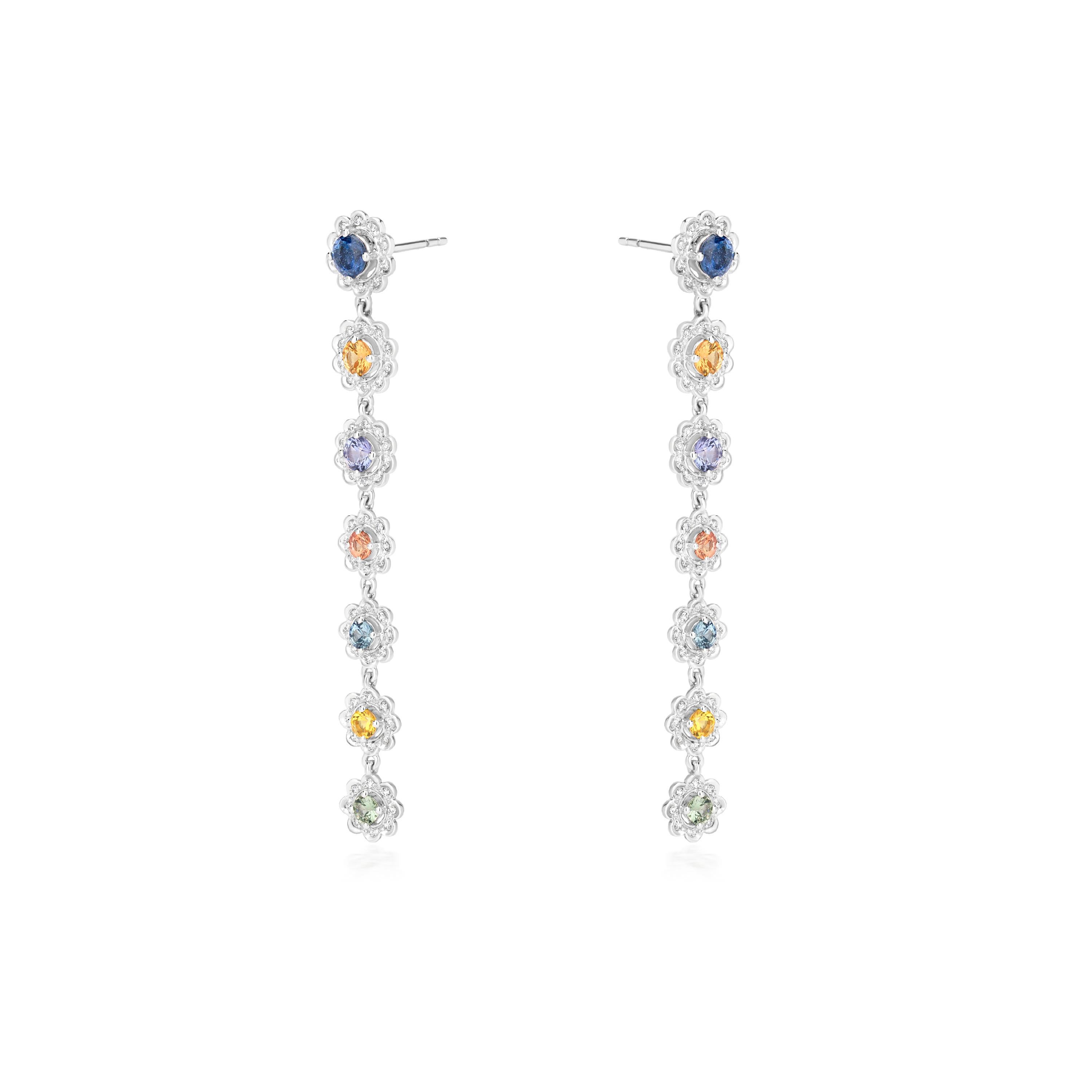 These Gemistry stunning 18k white gold earrings will add a lot of glitter to your attire. To give it a modern jewelry look, these droplets are aligned with colorful 14 sapphires and surrounded by 124 diamonds in a flower shape. The diamonds have a
