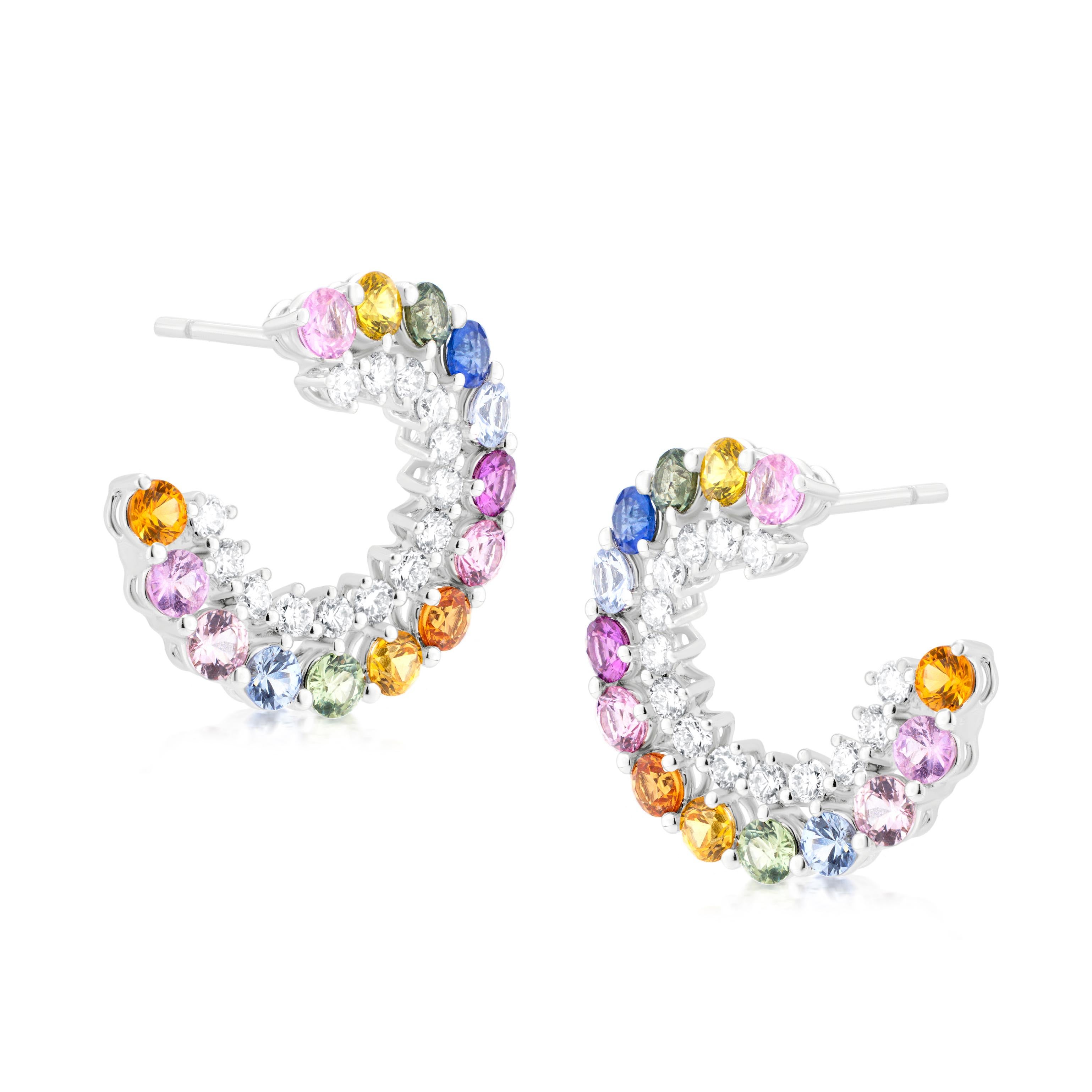 Crescent Earrings
These Rainbow Sapphire and Diamond  earrings feature a crescent design, adorned with a vibrant rainbow of sapphires and sparkling diamonds. The 18K gold setting showcases a captivating array of colors, including pink, yellow, blue,