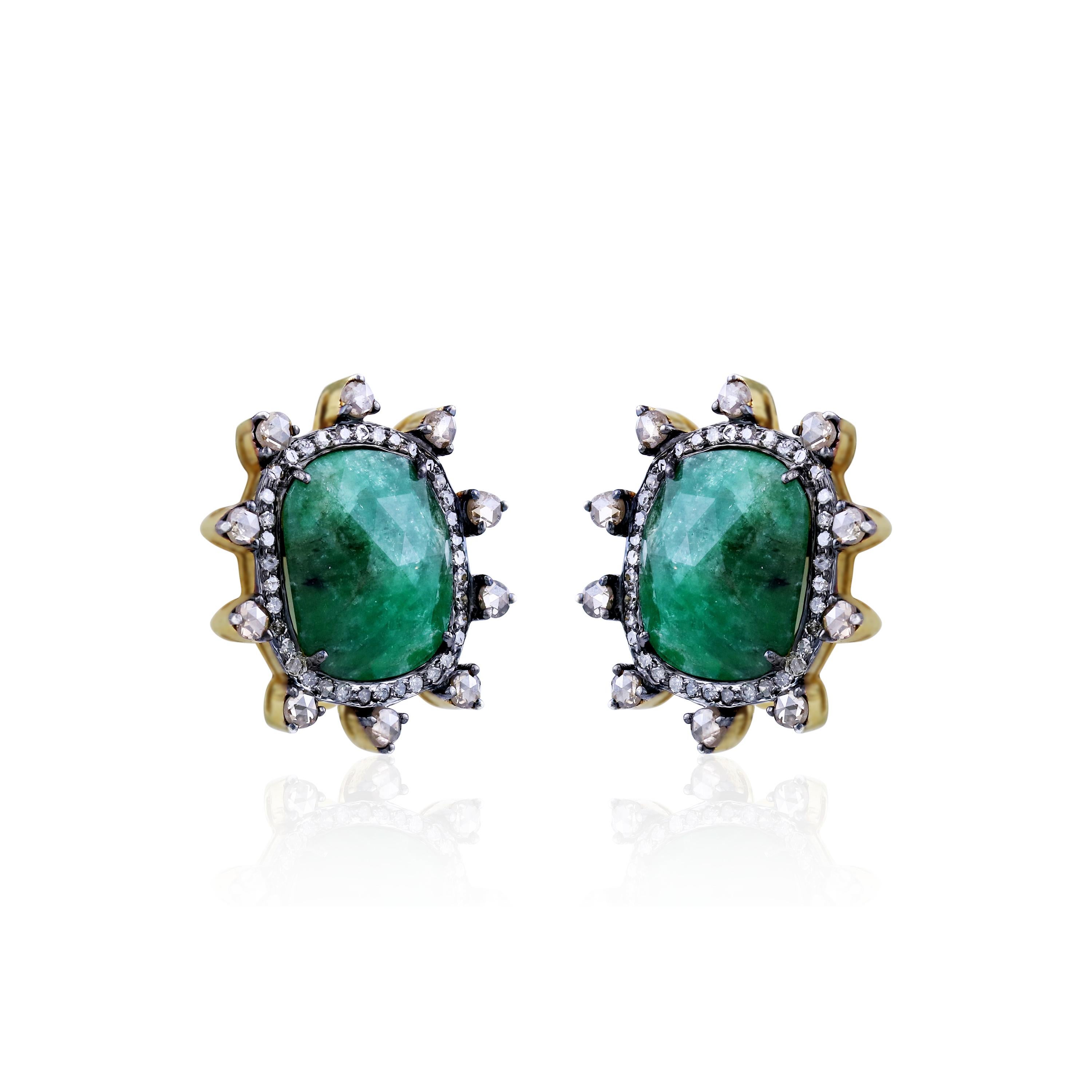 This vintage Gemistry Victorian  stud earrings features 10 Cts. cushion cut emeralds at the center enclosed in a halo of pave white diamonds. The pave white diamonds mounted on black rhodium polished 18K Yellow Gold and 925 Sterling Silver present a