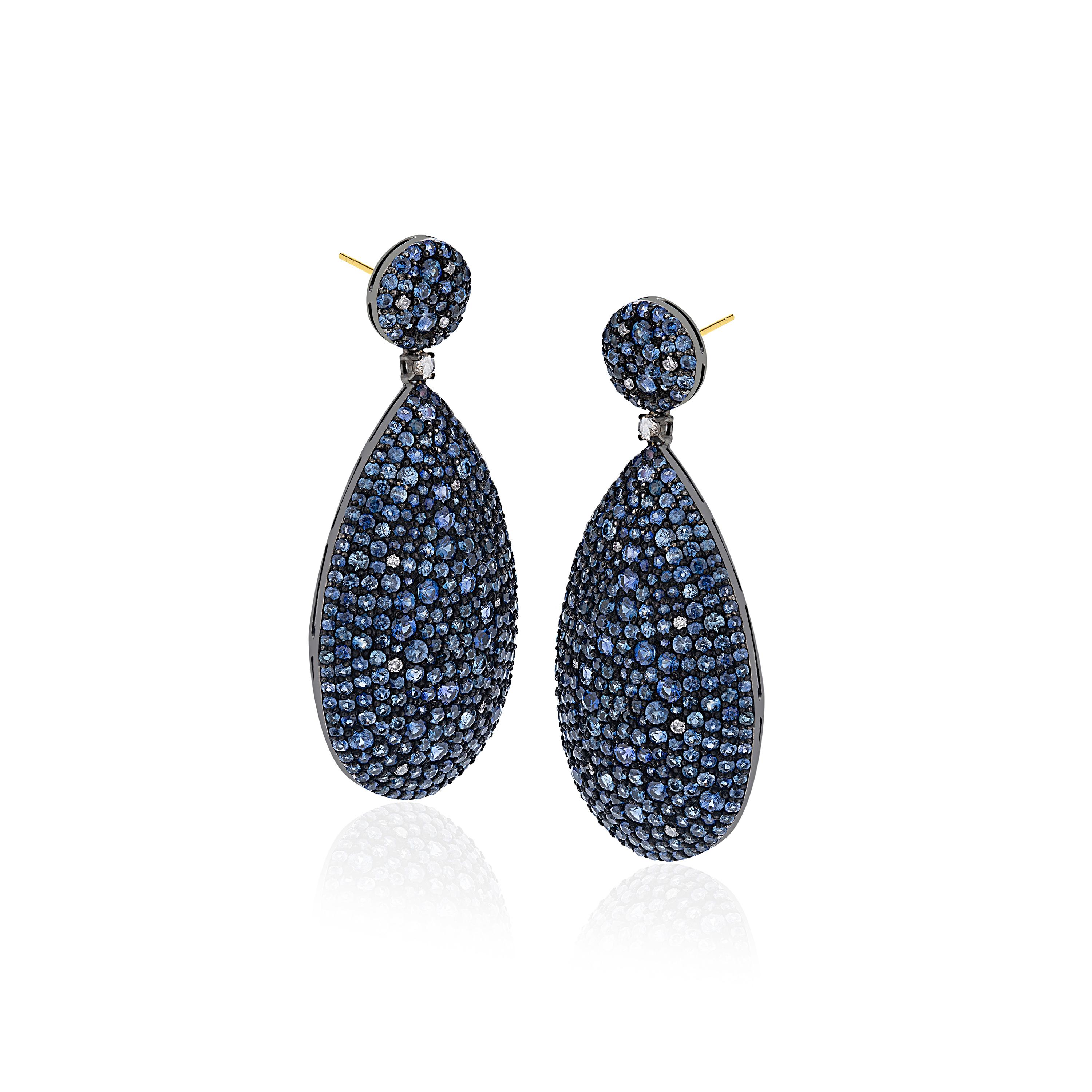 Make a statement with these Gemistry Victorian drop earrings in 18K White Gold & Black Rhodium Silver, inspired by the glitch and glam these pave pear drops of Blue Sapphire accentuated by diamonds sway with glamour from round Blue Sapphire