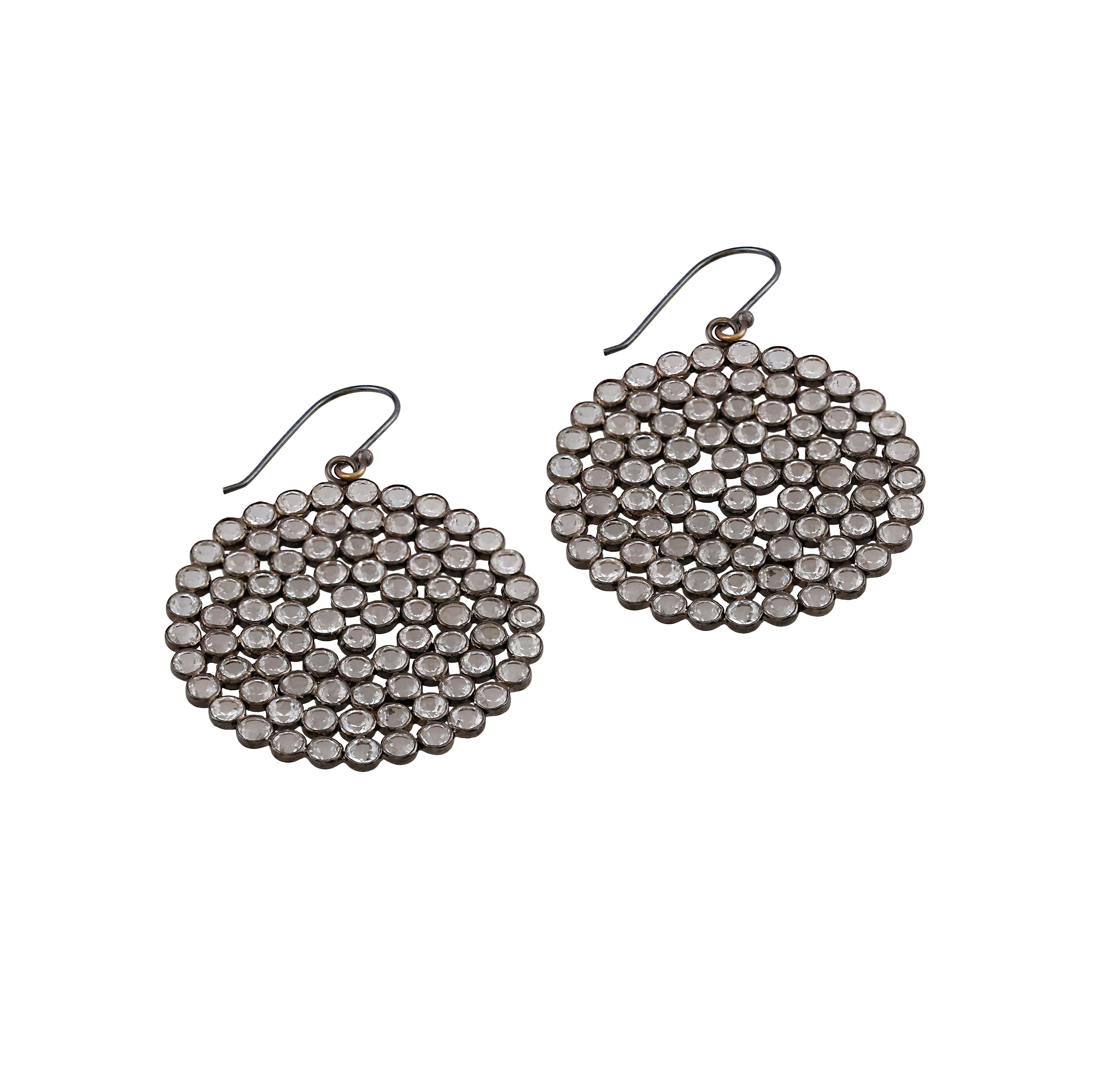 You will enjoy the glistening colors of these sterling silver drop earrings that Gemistry made! Brilliant white topazes suspended on lever backs are featured in the traditional circular shape. For an exquisite coordinated look, pair these with a