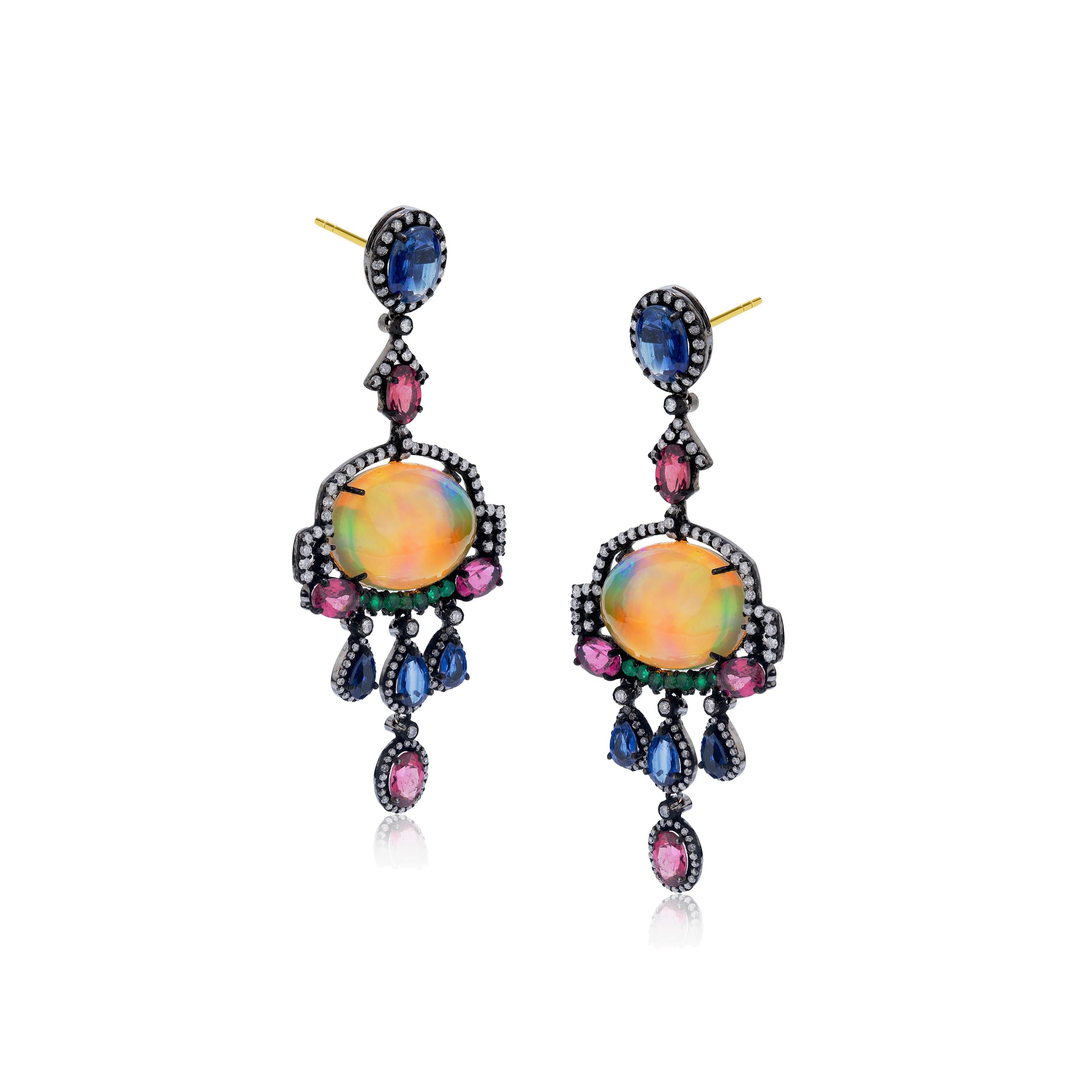 This fascinating multi stone Victorian earrings from Gemistry are carved of 18K/925 Black Rhodium Sterling Silver. The earpieces are well embellished with mix diamonds weighing 1.78 Cts. Multiple gemstones like round cut emeralds, pink tourmaline