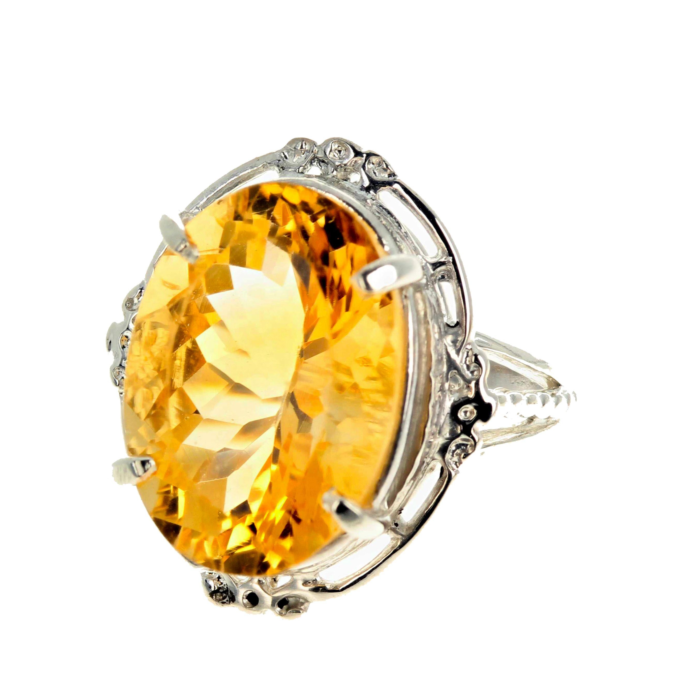 This glittering oval cut natural yellow goldy 11.52 carat Citrine (17.8mm x 13mm) is set in an interesting and unique sterling silver ring size 7 sizable (we size for free).  Citrine is believed to promote success, abundance and clear thinking.  